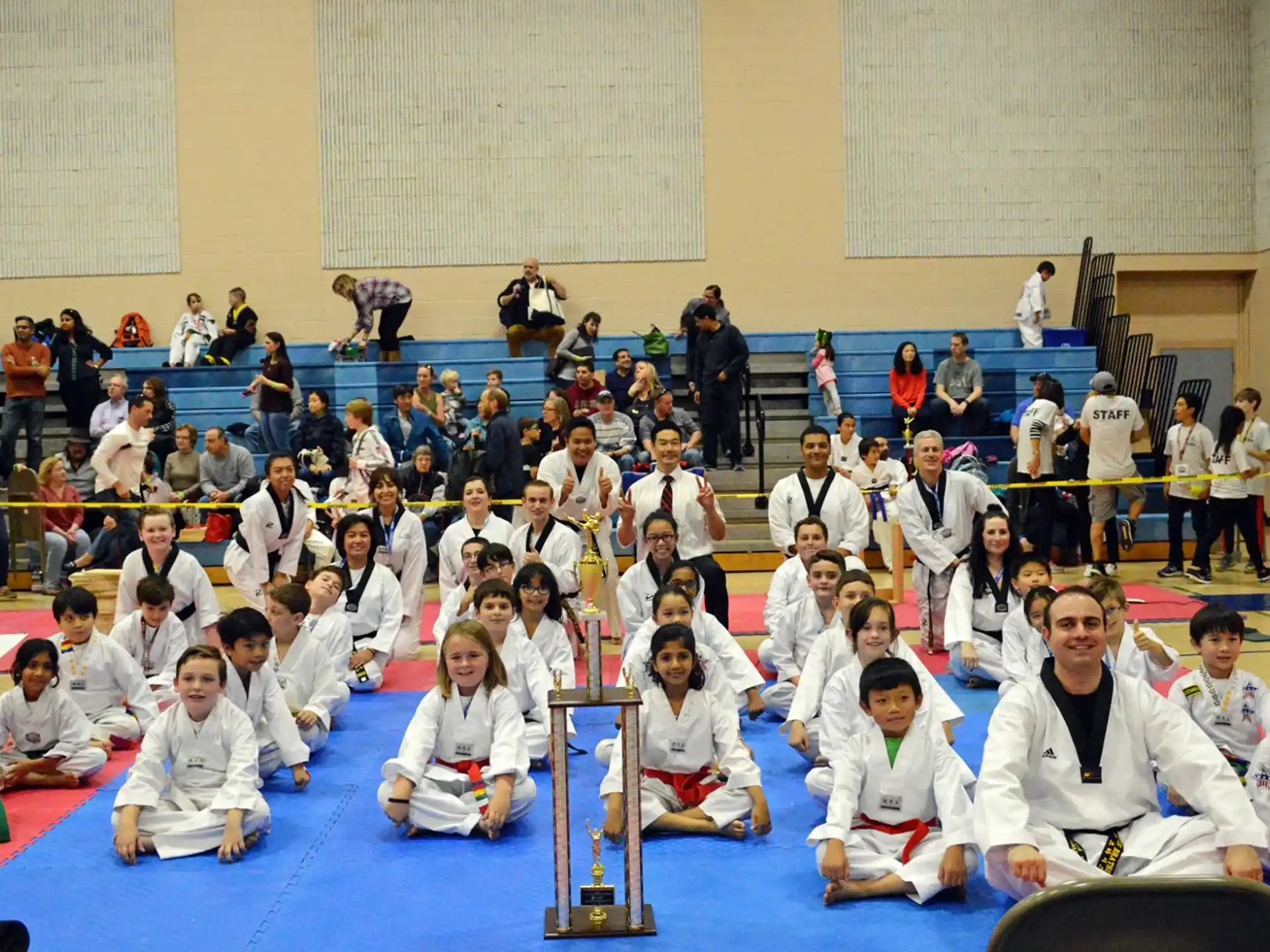 a group of people in white karate uniforms posing for a photo