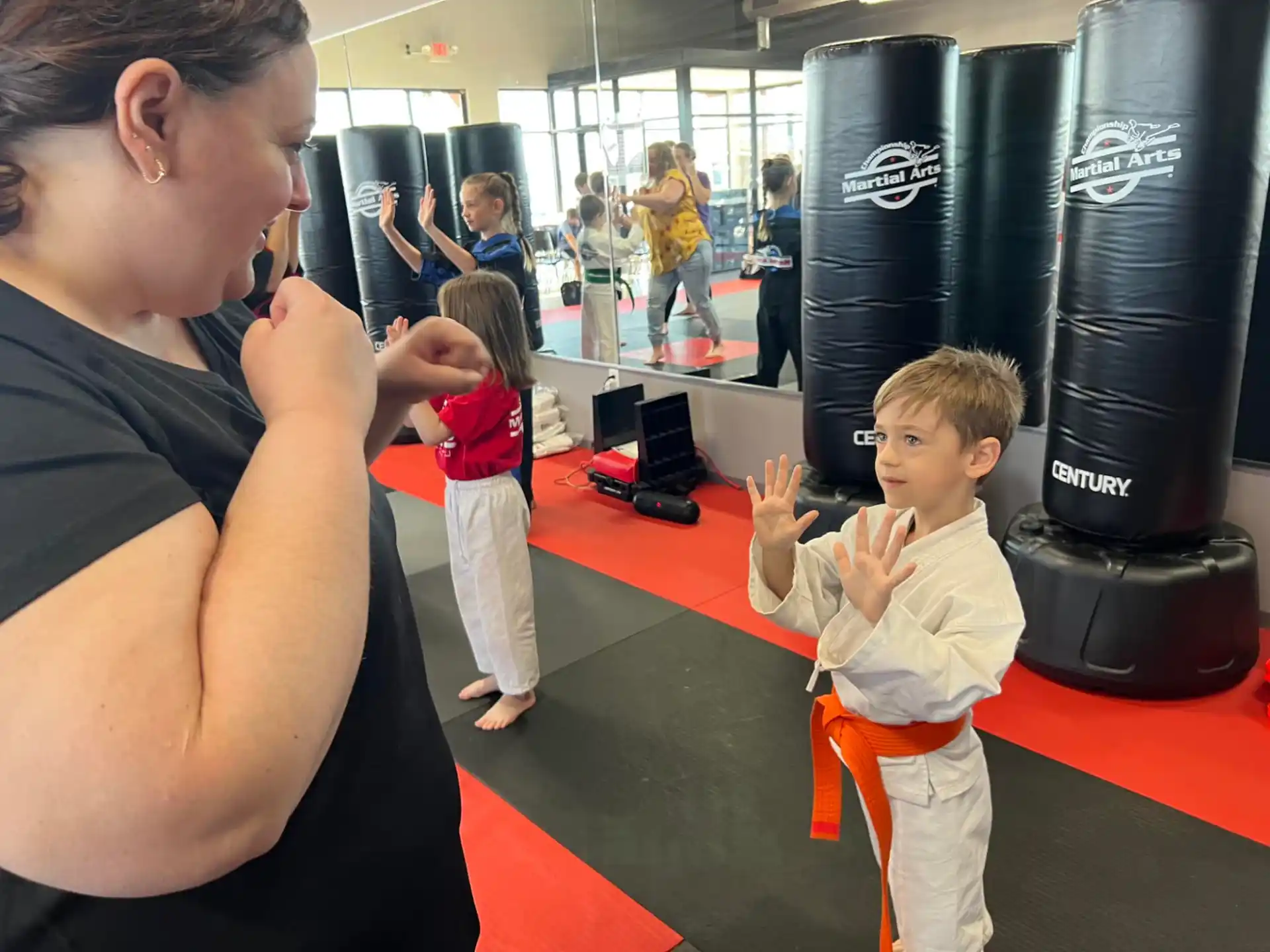a person and a child in a room with a large black machine