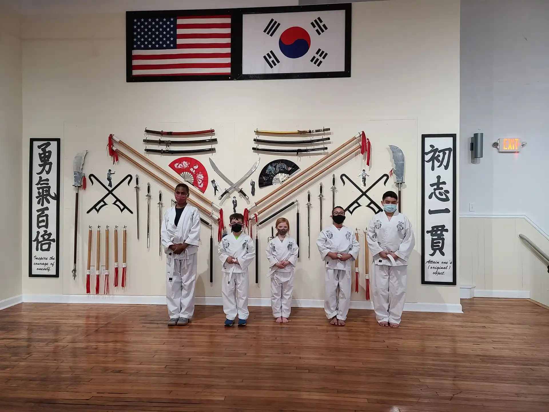 a group of people in white uniforms holding swords in a room with flags