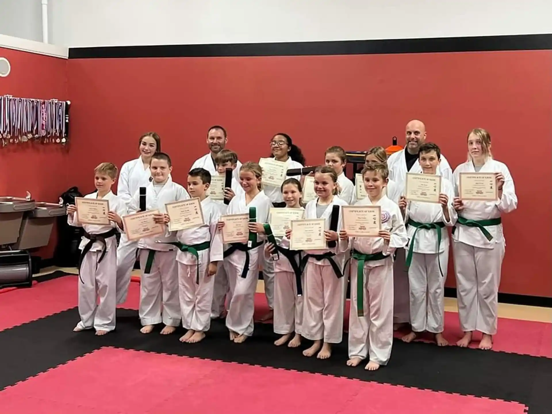 a group of people holding certificates