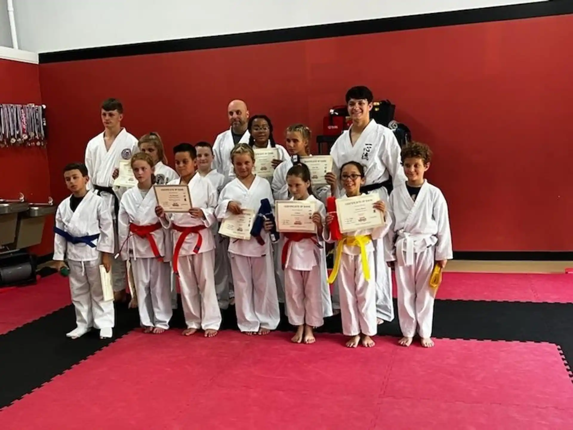a group of people holding certificates