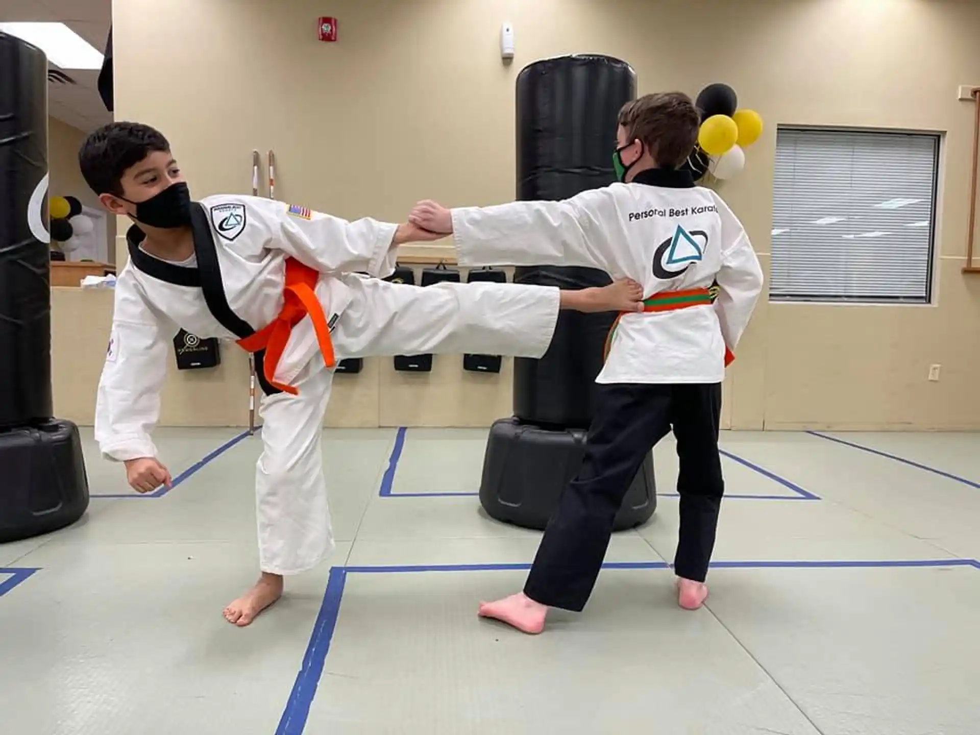 a couple of people in karate uniforms