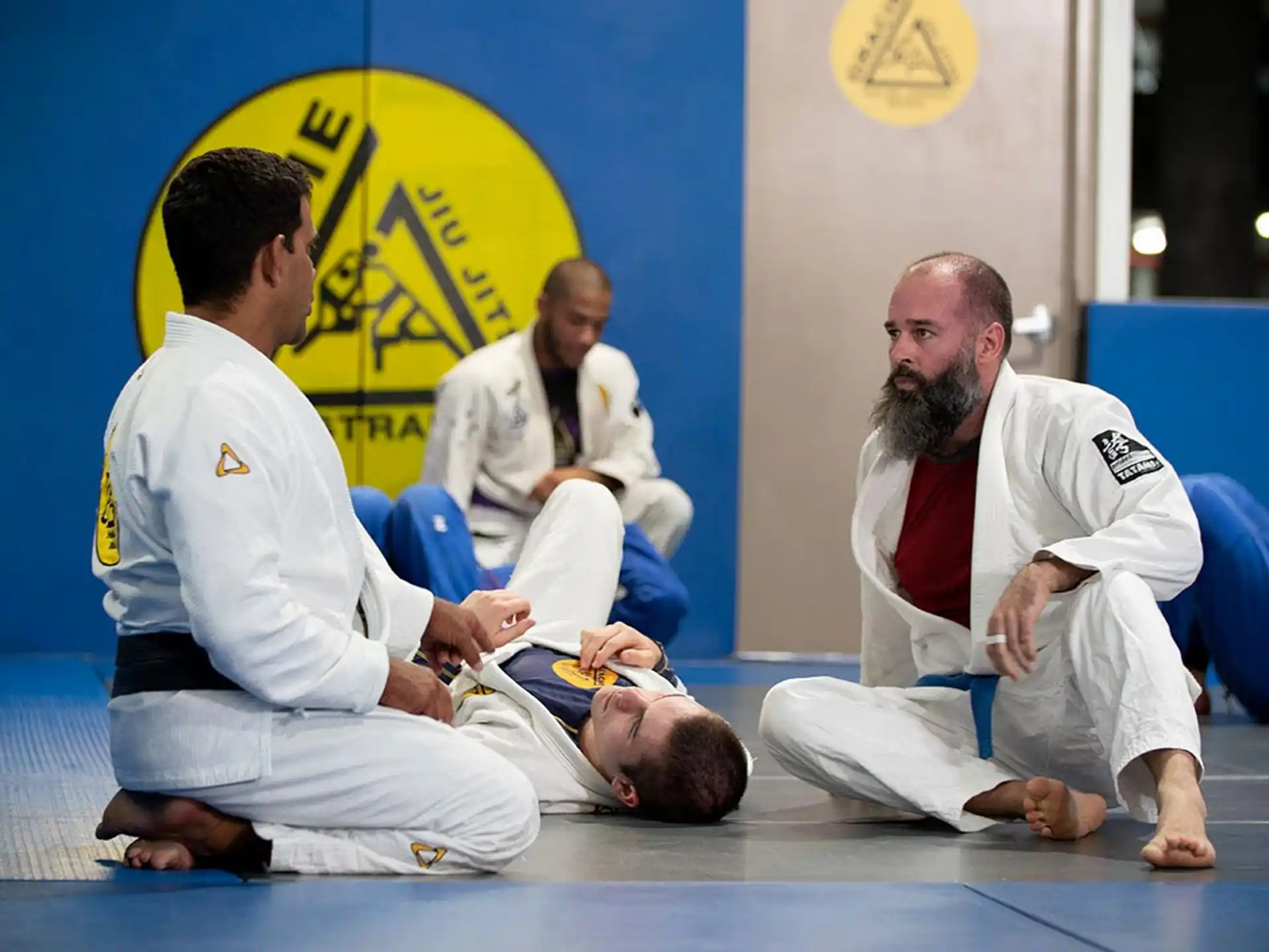 a group of men in white karate uniforms