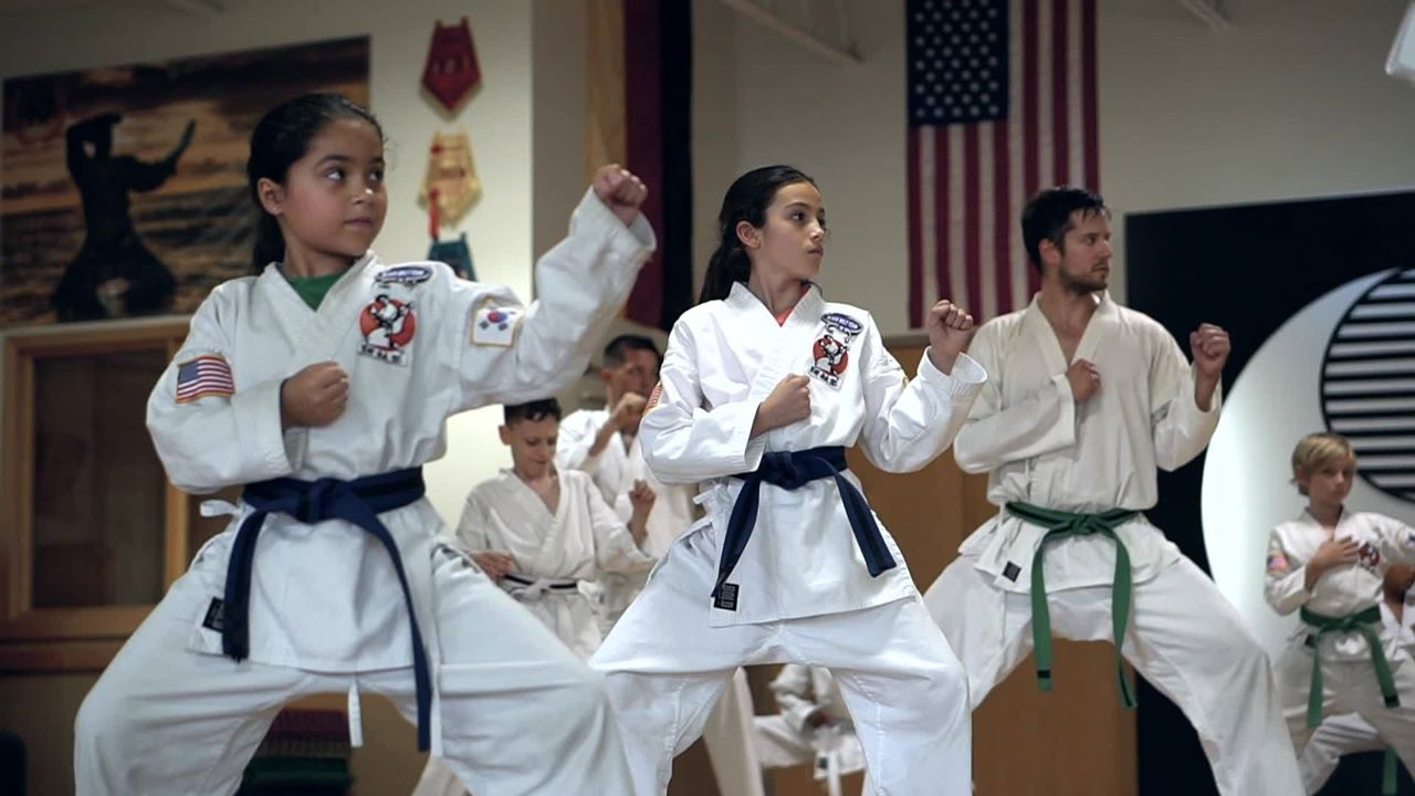 a group of people in karate uniforms