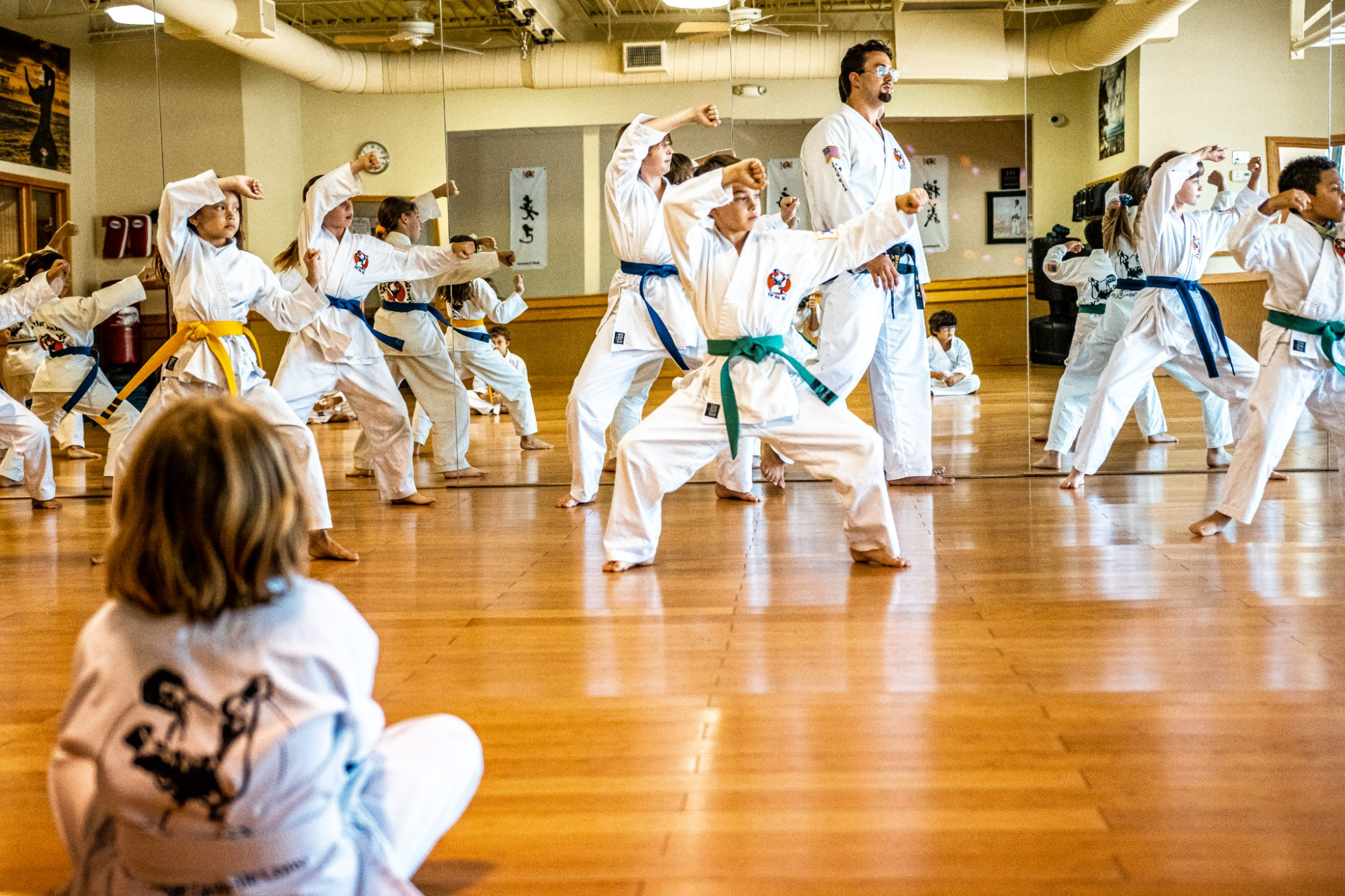 a group of people in white karate uniforms