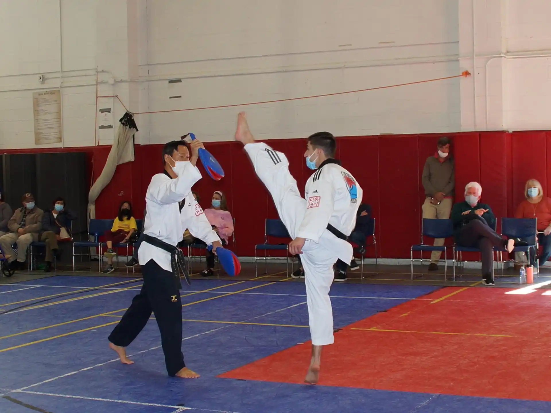 a man and woman in karate uniforms