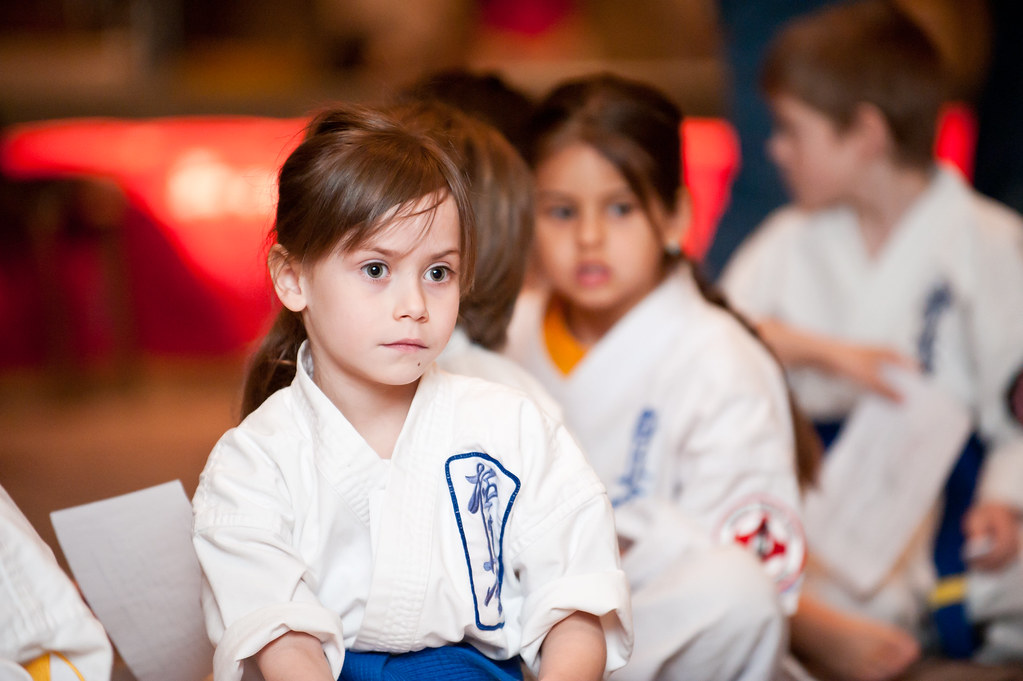 a group of children in white shirts