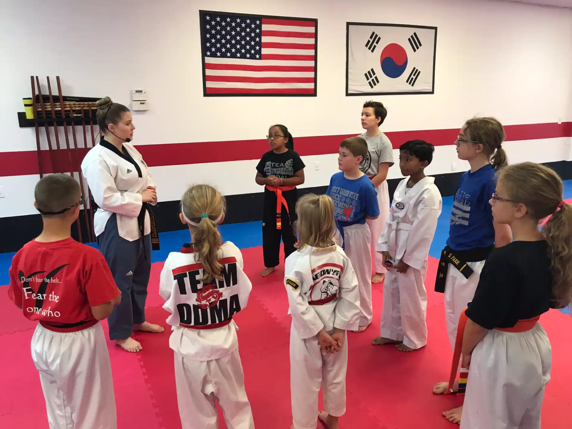 a group of children in karate uniforms