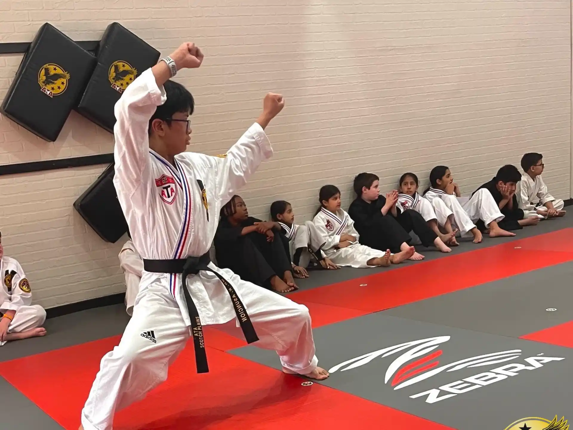 a person in a karate uniform holding a flag