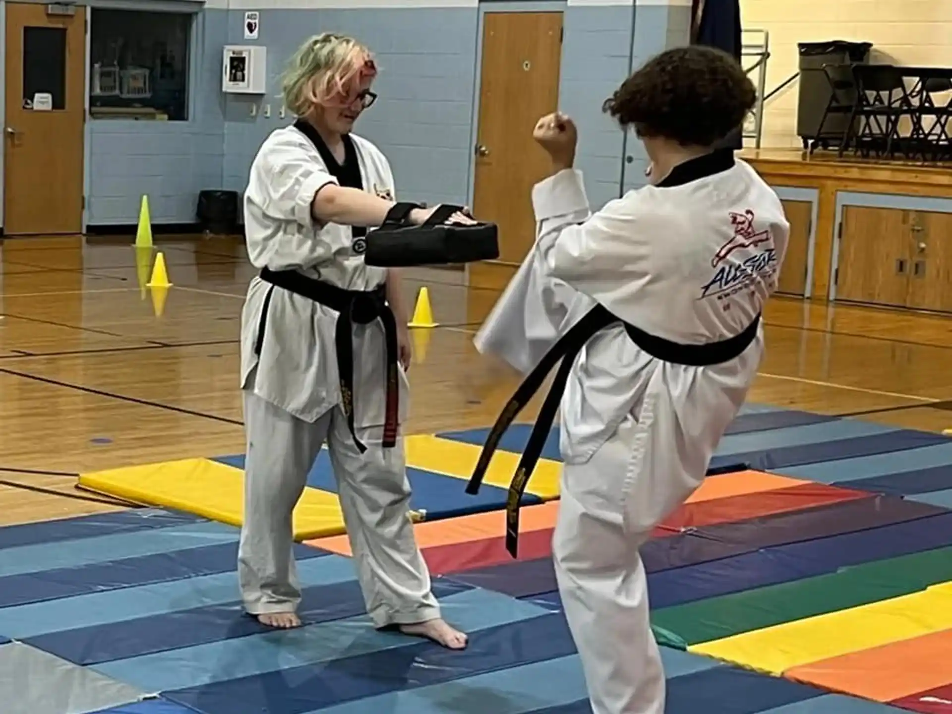 a couple of women in karate uniforms