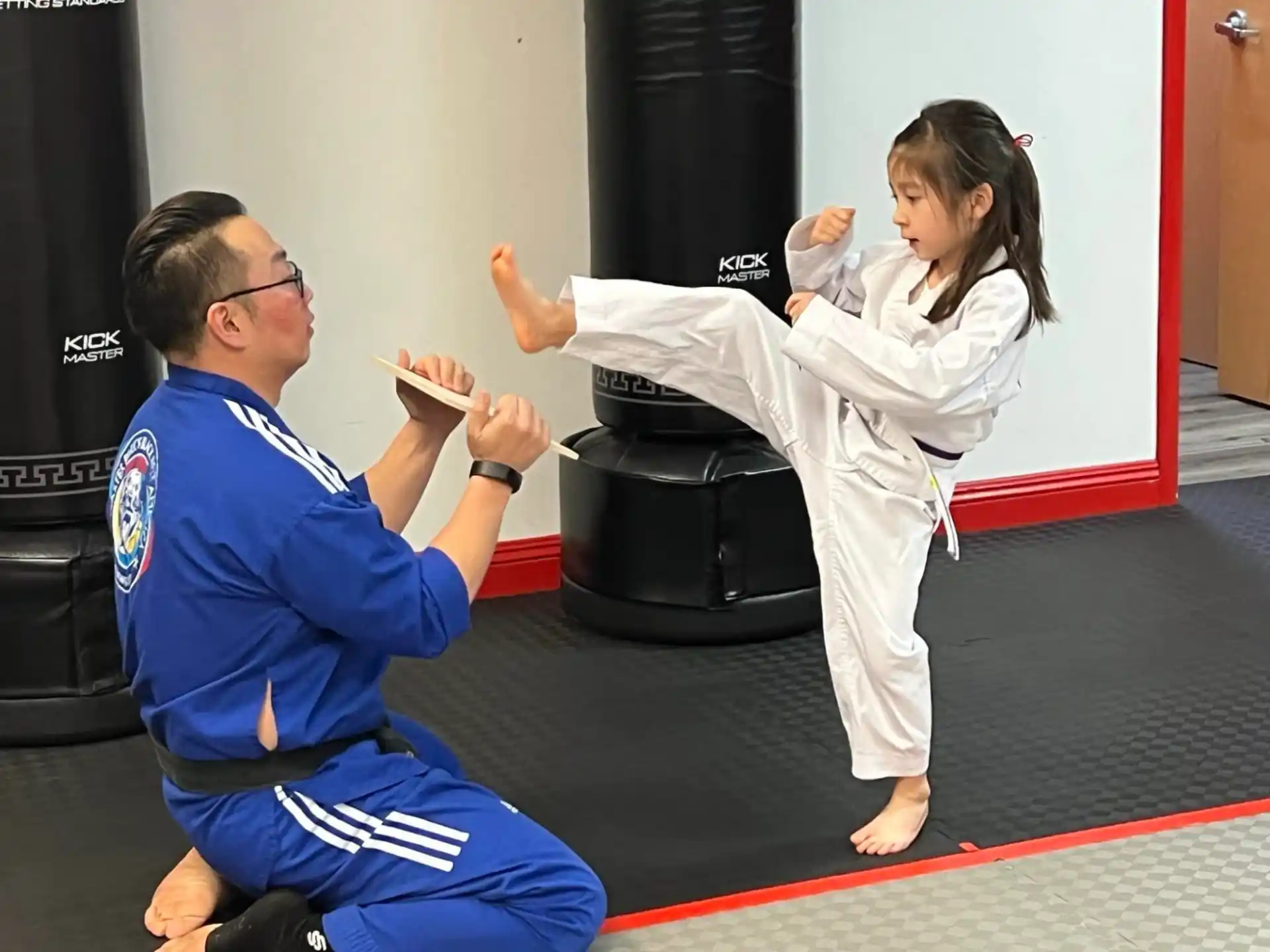 a man and a woman in karate uniforms