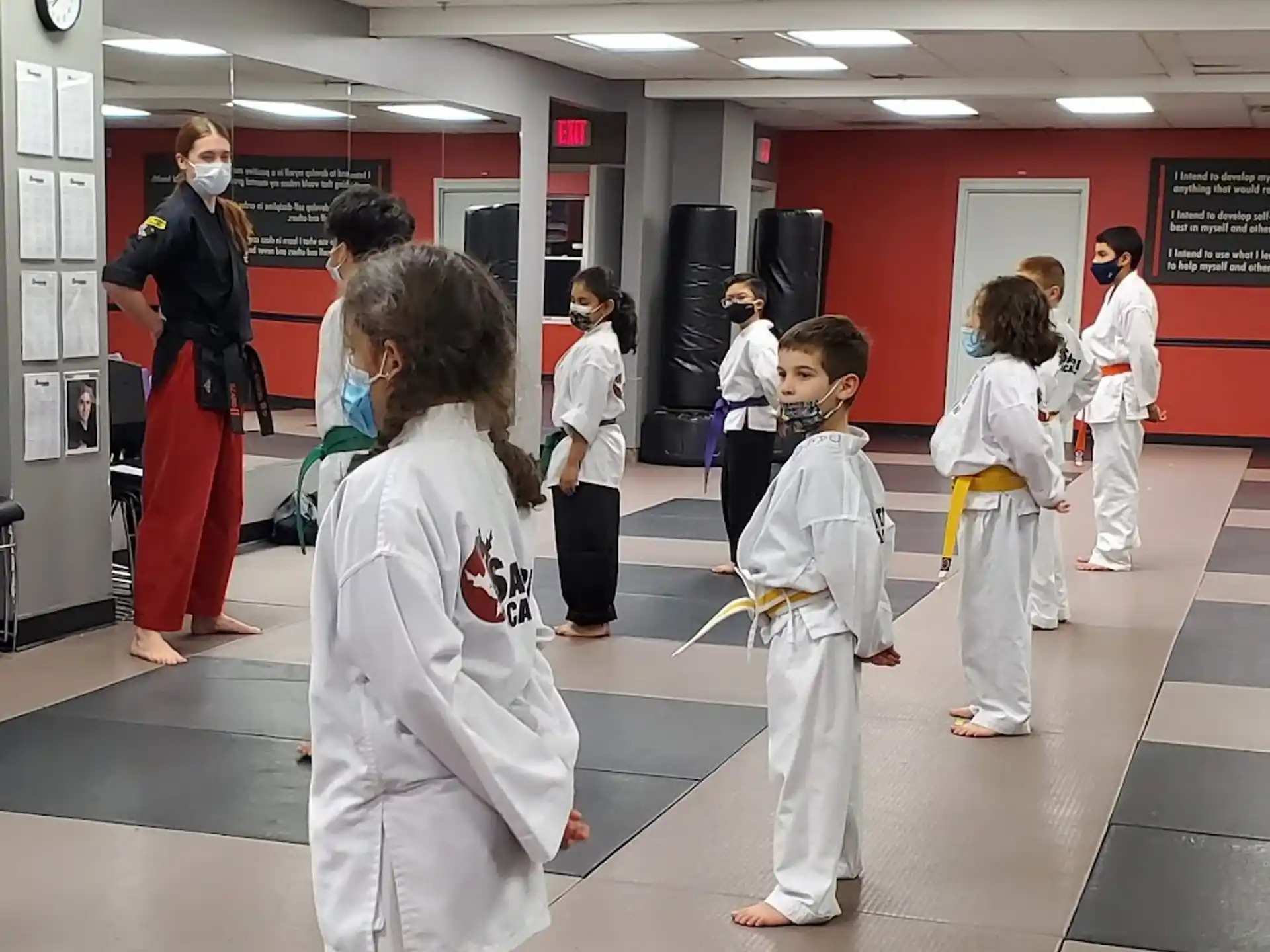 a group of people in white karate uniforms