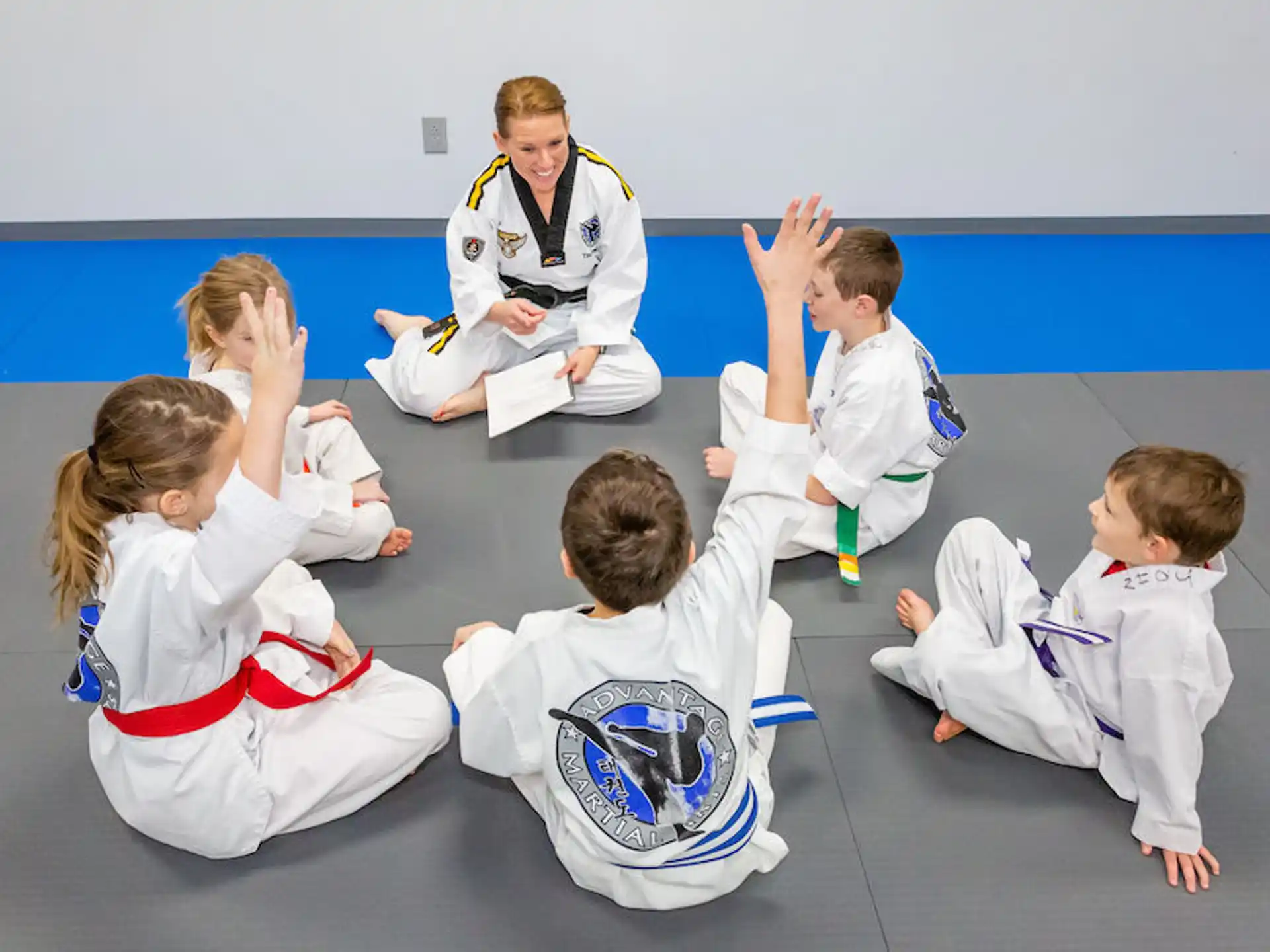 a group of children in karate uniforms