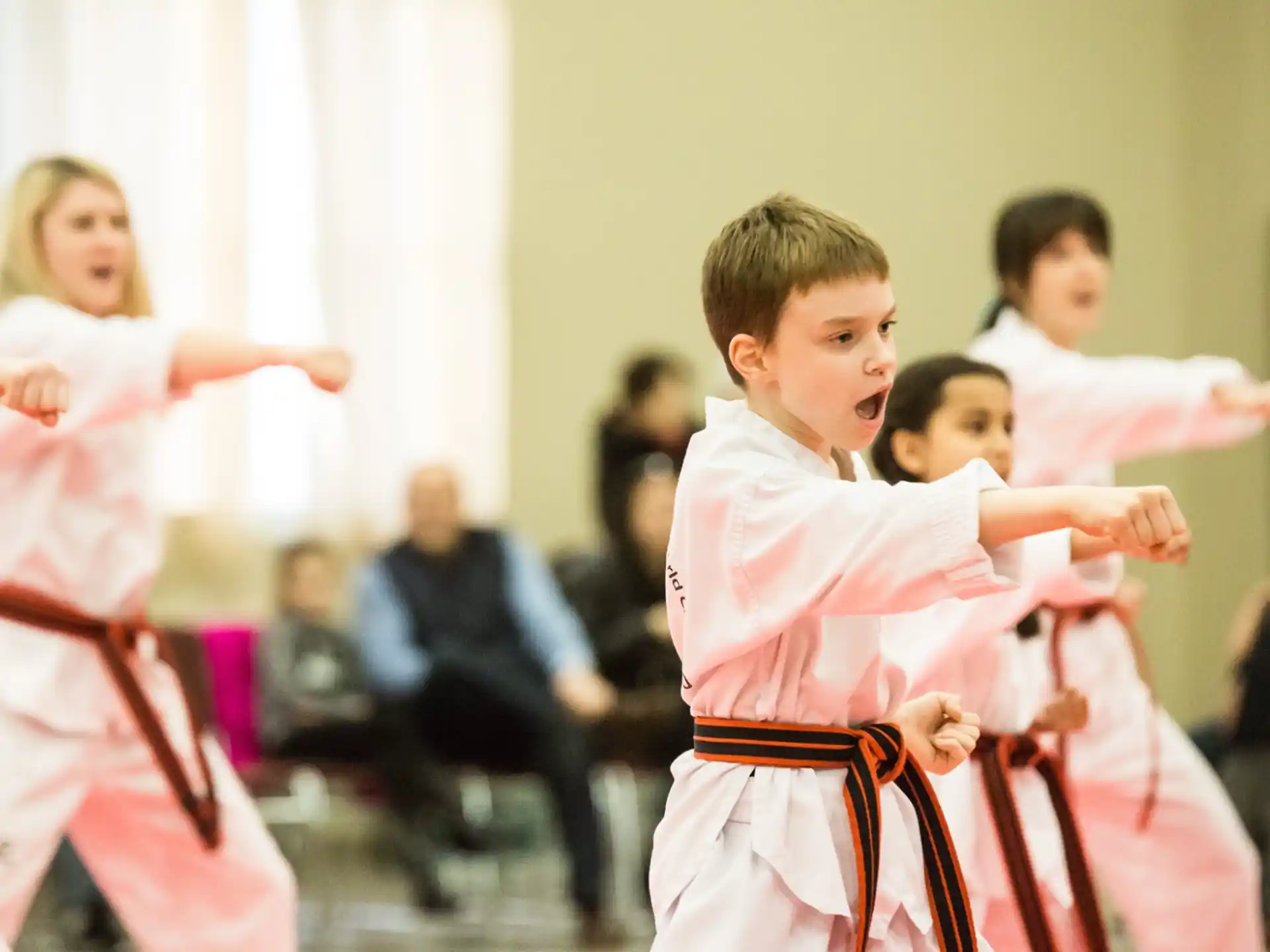 a group of children in karate uniforms