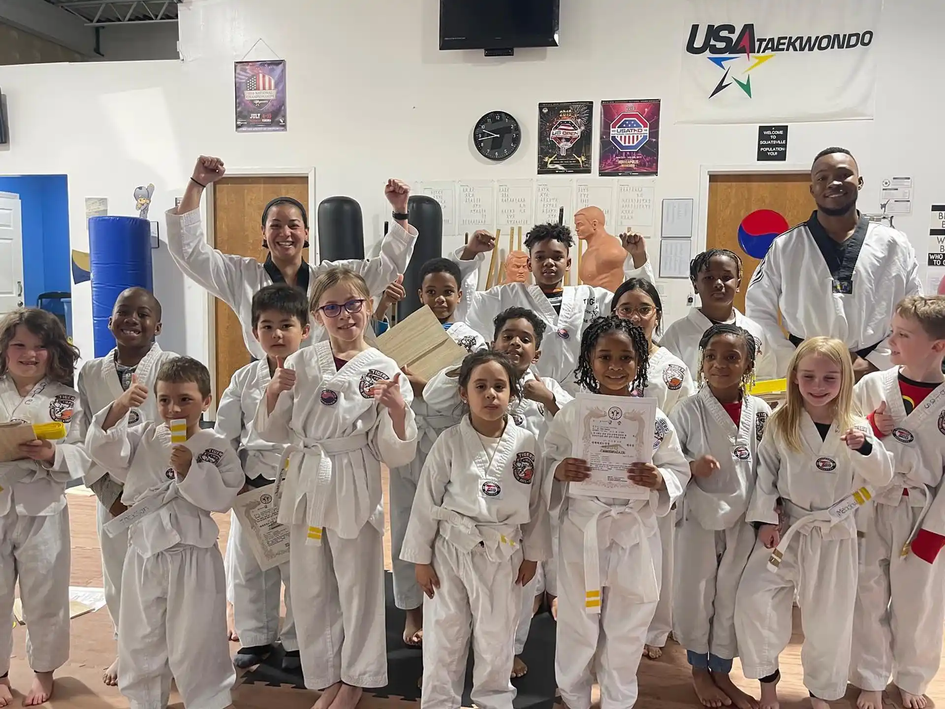 a group of people in white karate uniforms