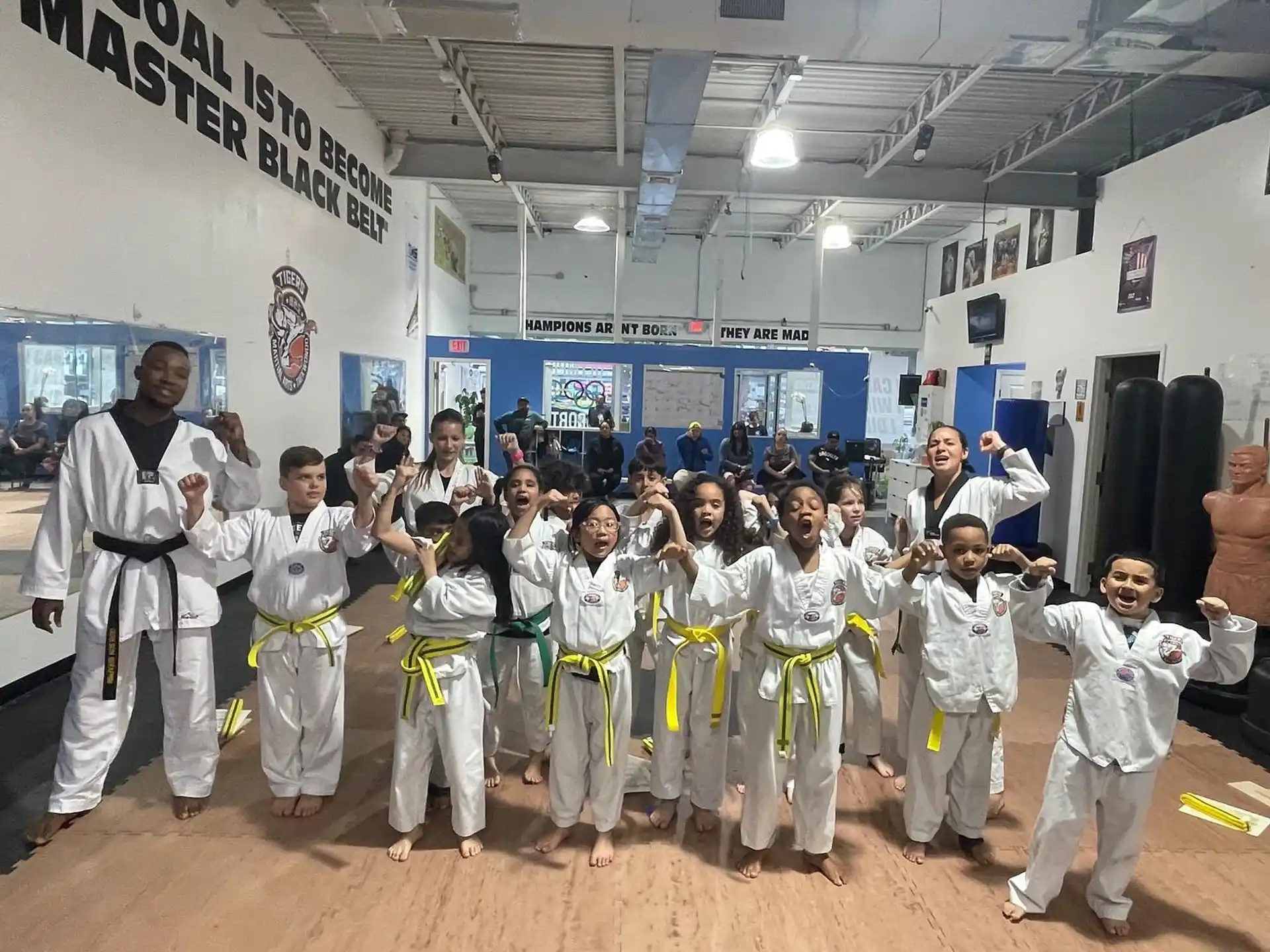 a group of people in white karate uniforms posing for a photo