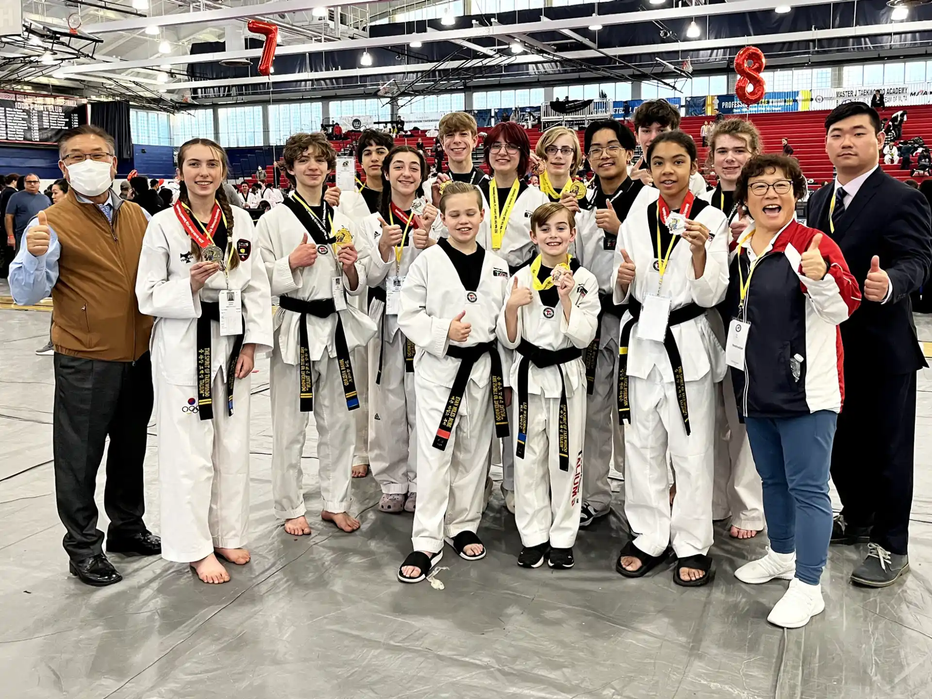 a group of people wearing white and black clothing