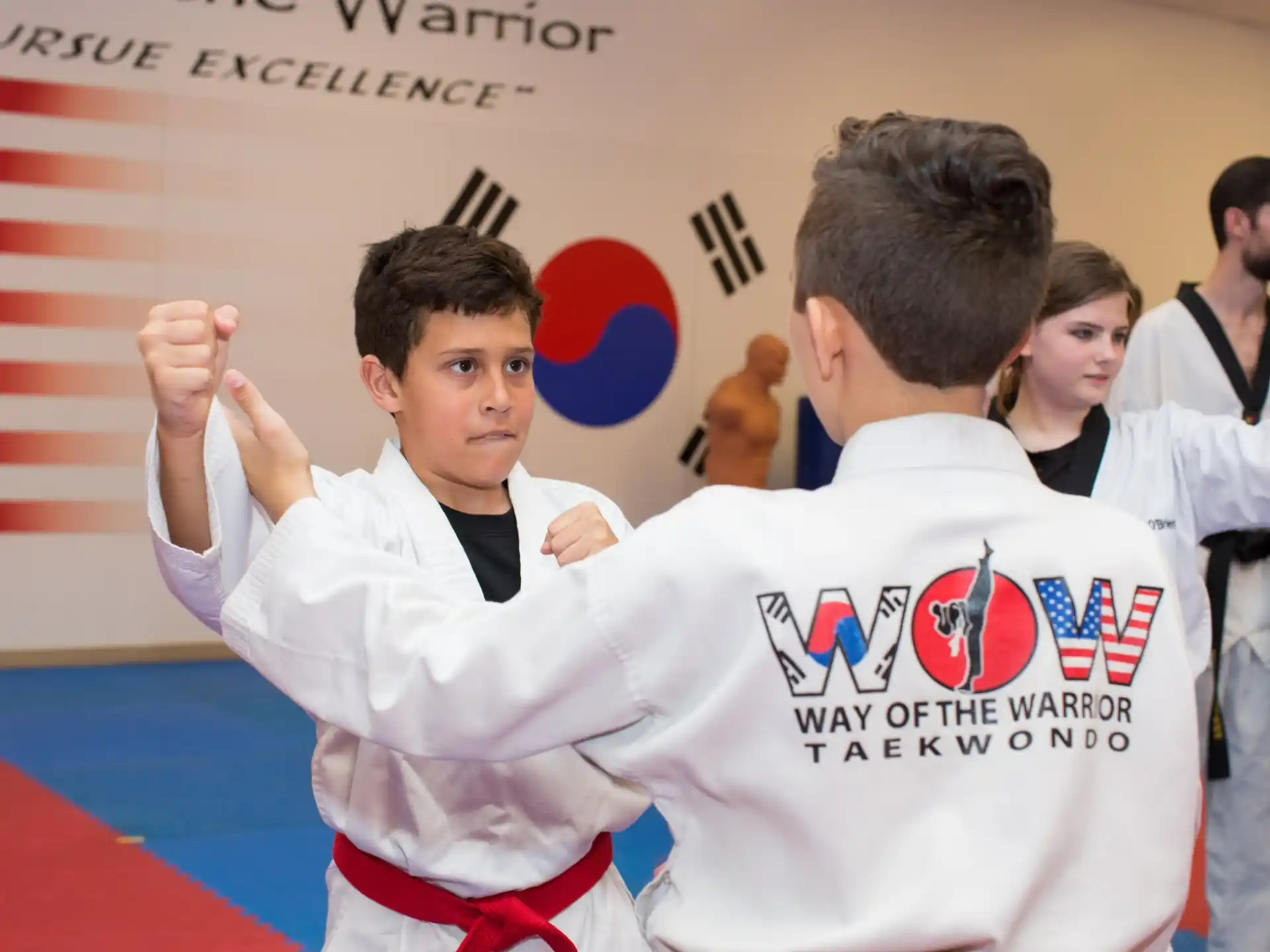 a man in a karate uniform with another man in a white shirt