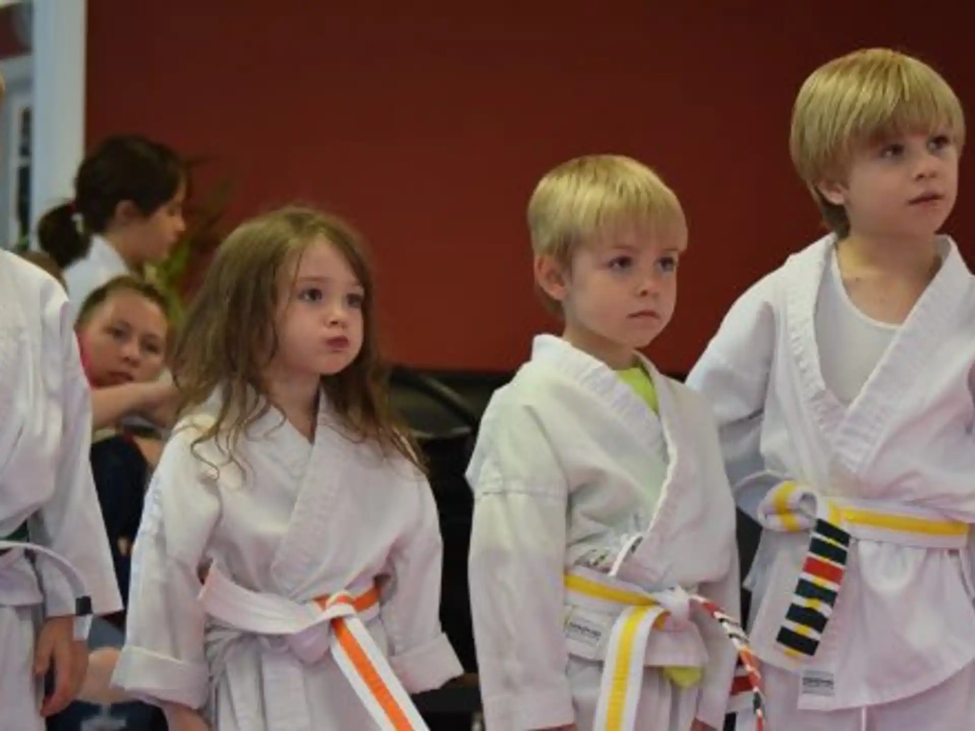a group of children in white shirts