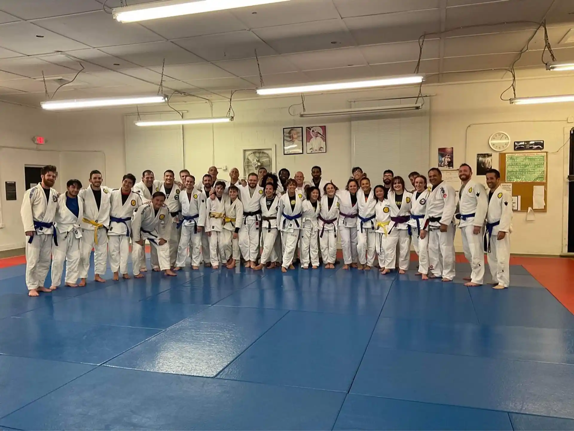 a group of people in white karate uniforms standing in a room