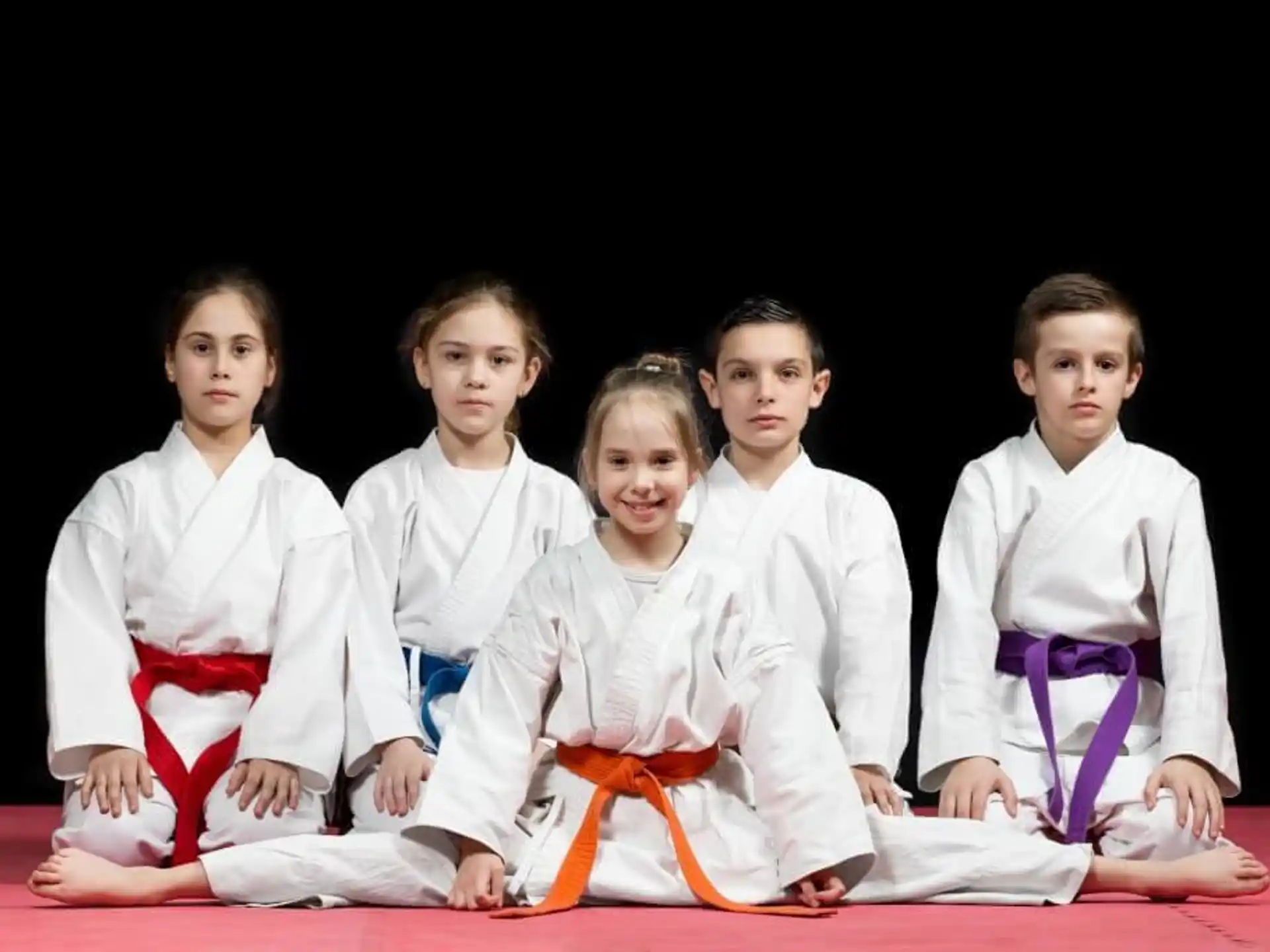 a group of girls in karate uniforms