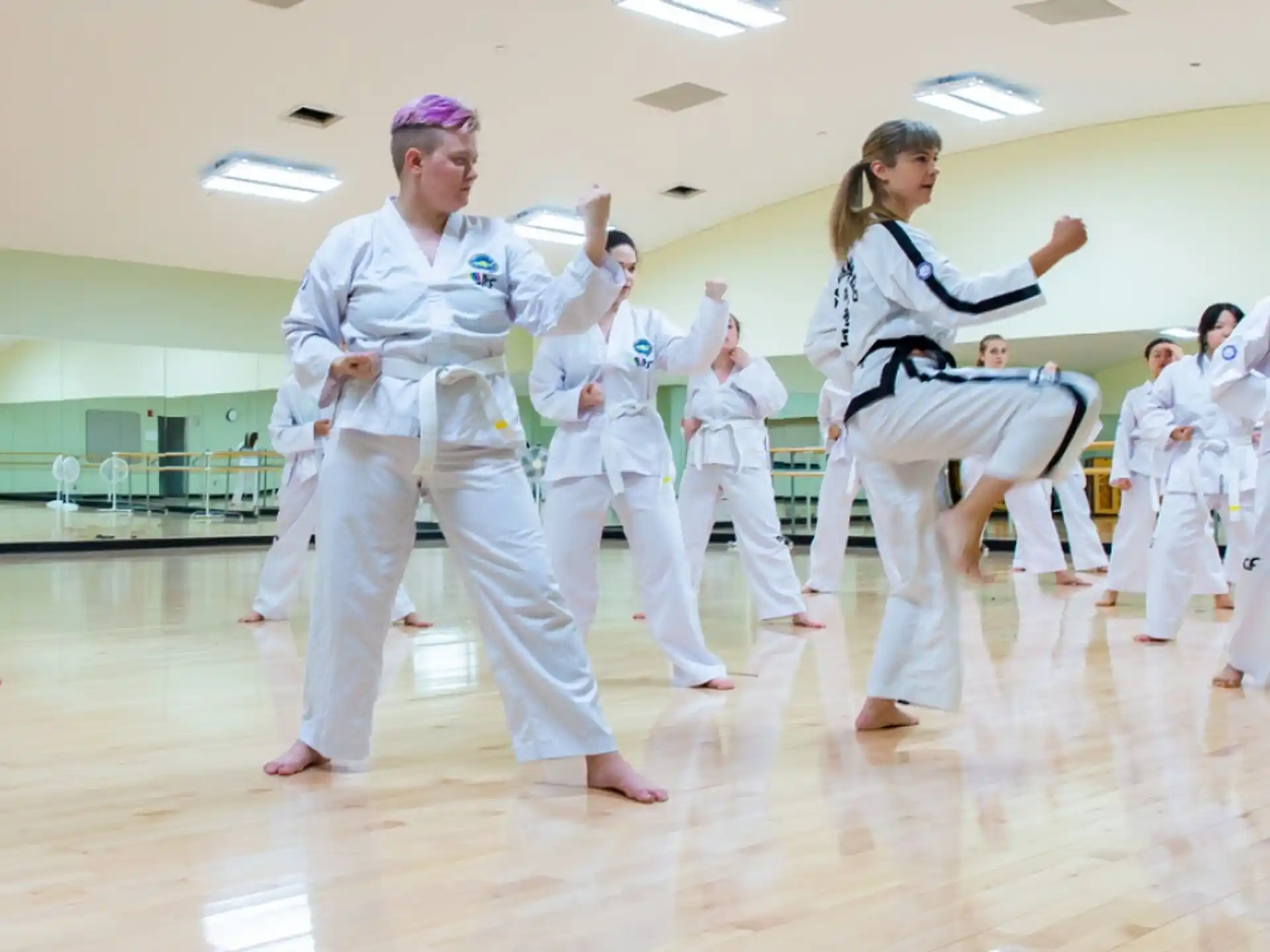 a group of people in white karate uniforms