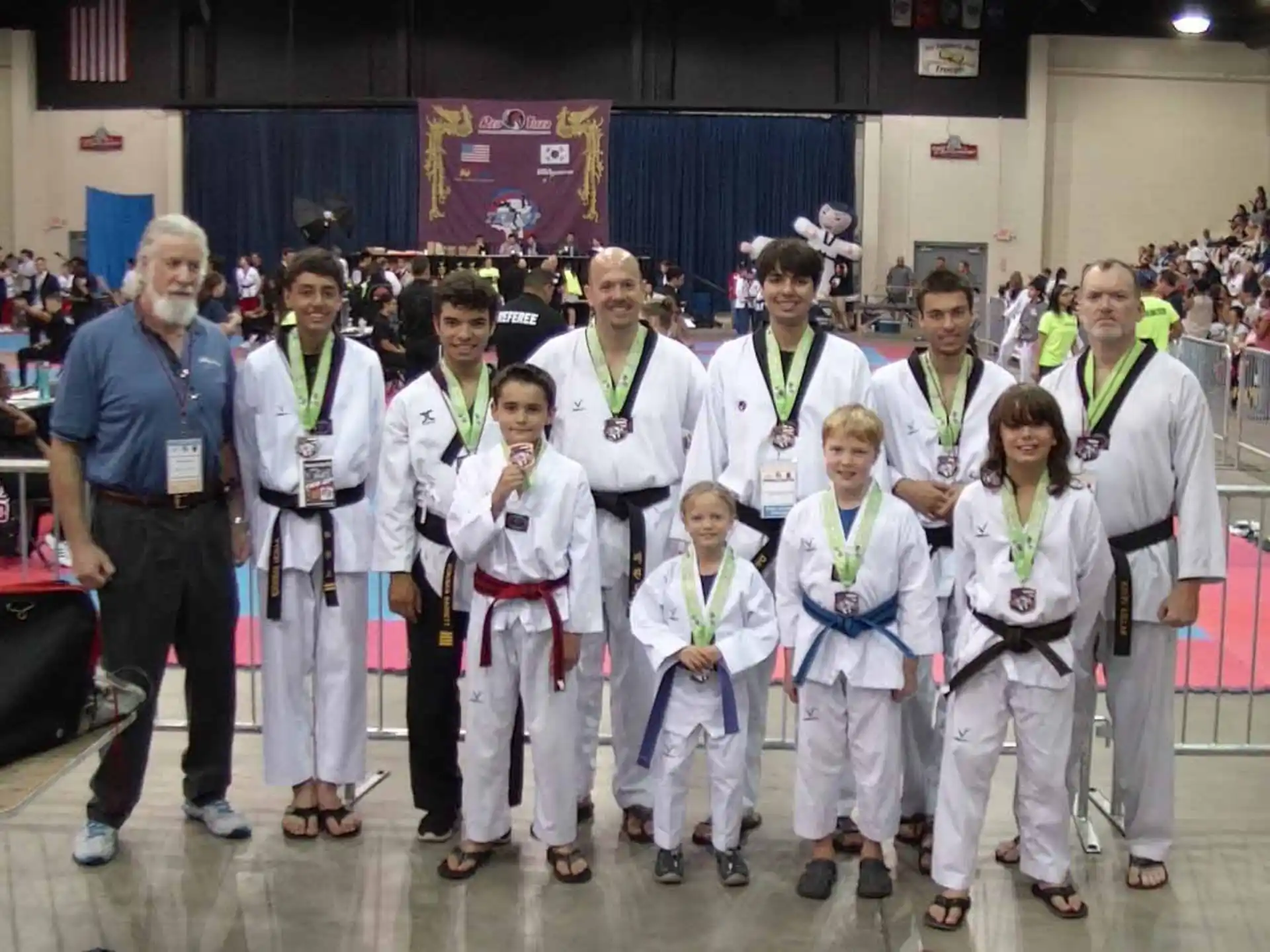 a group of people wearing white lab coats and badges