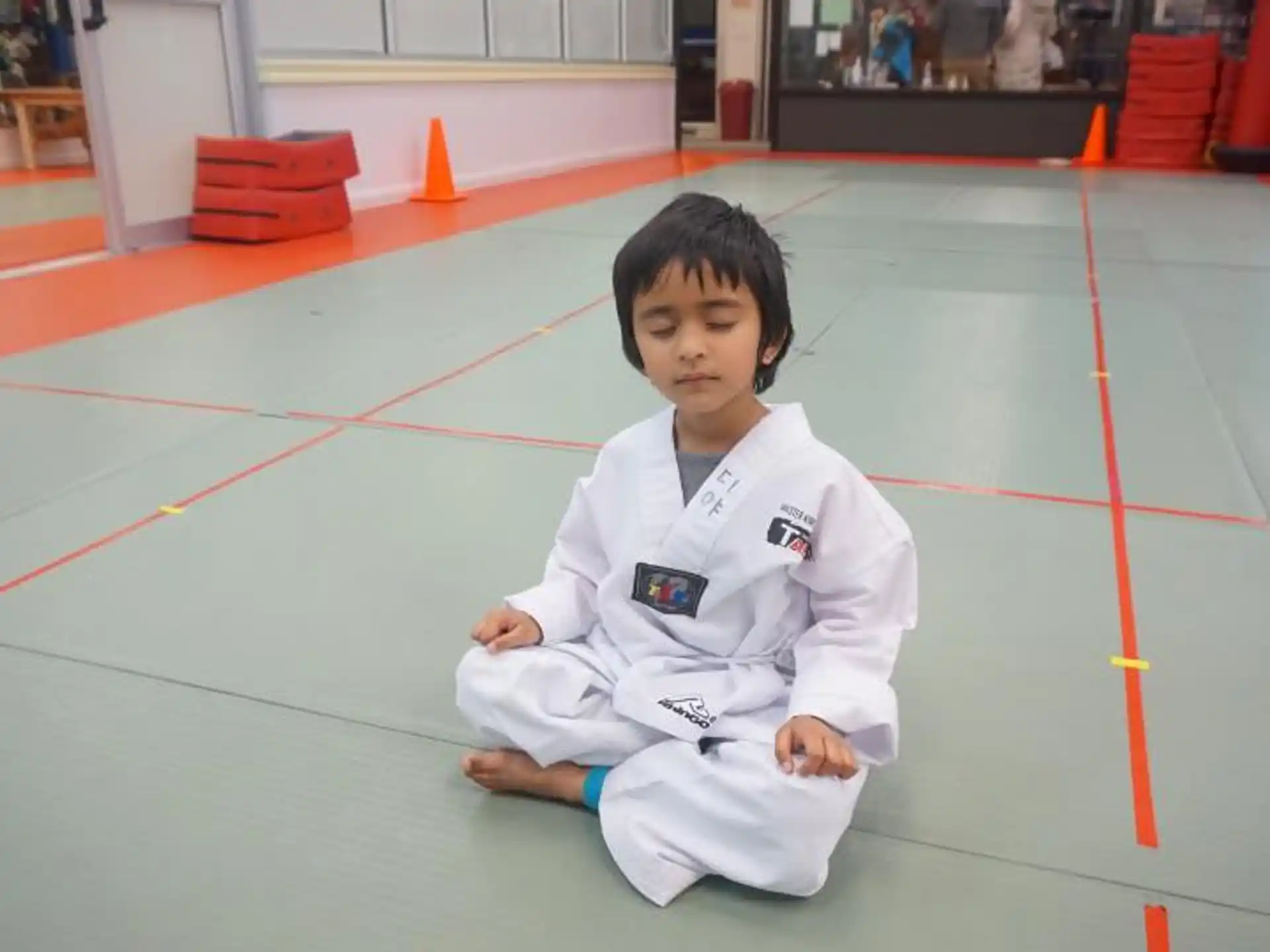 a young boy sitting on the floor