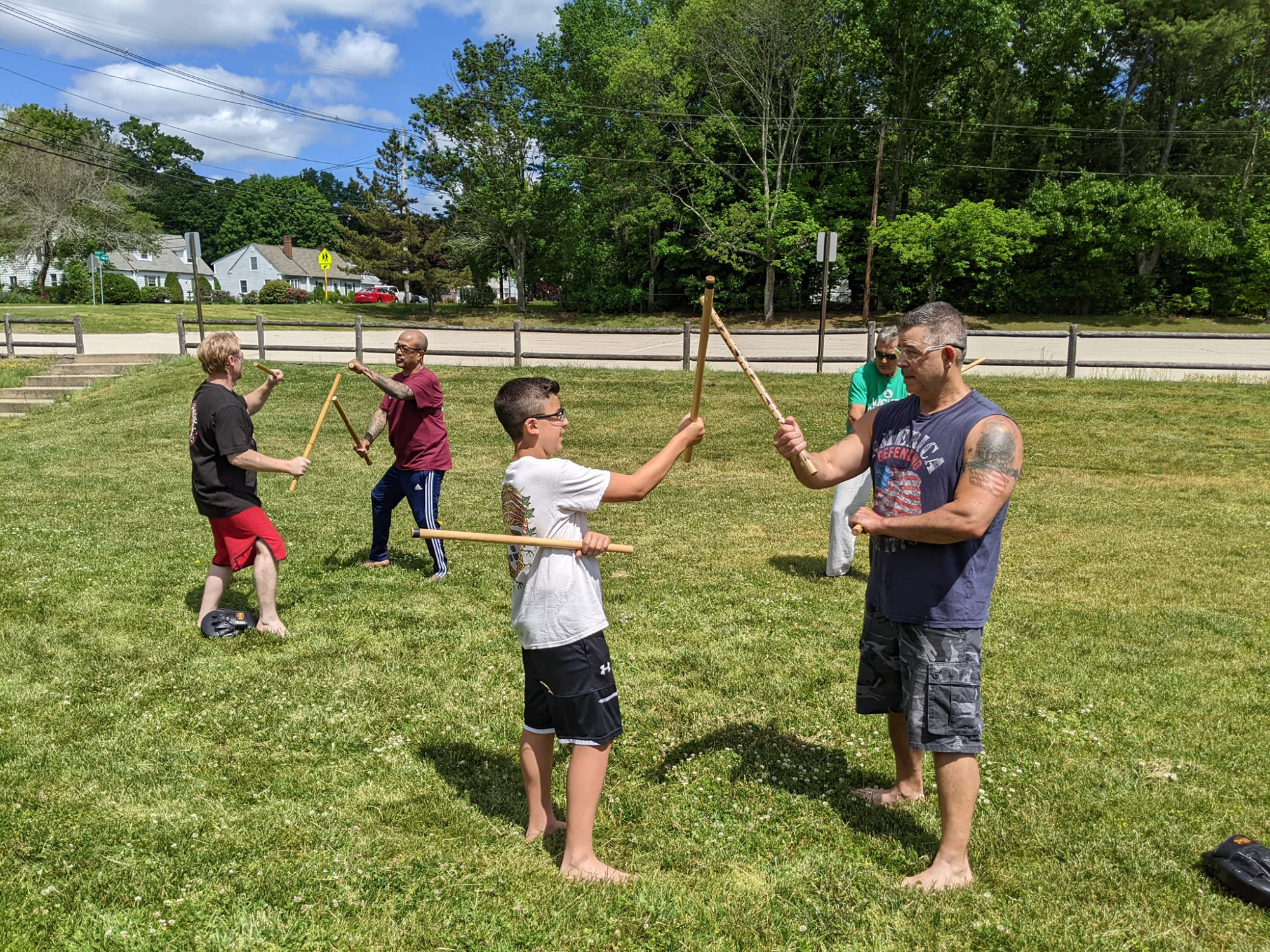 a group of people holding sticks