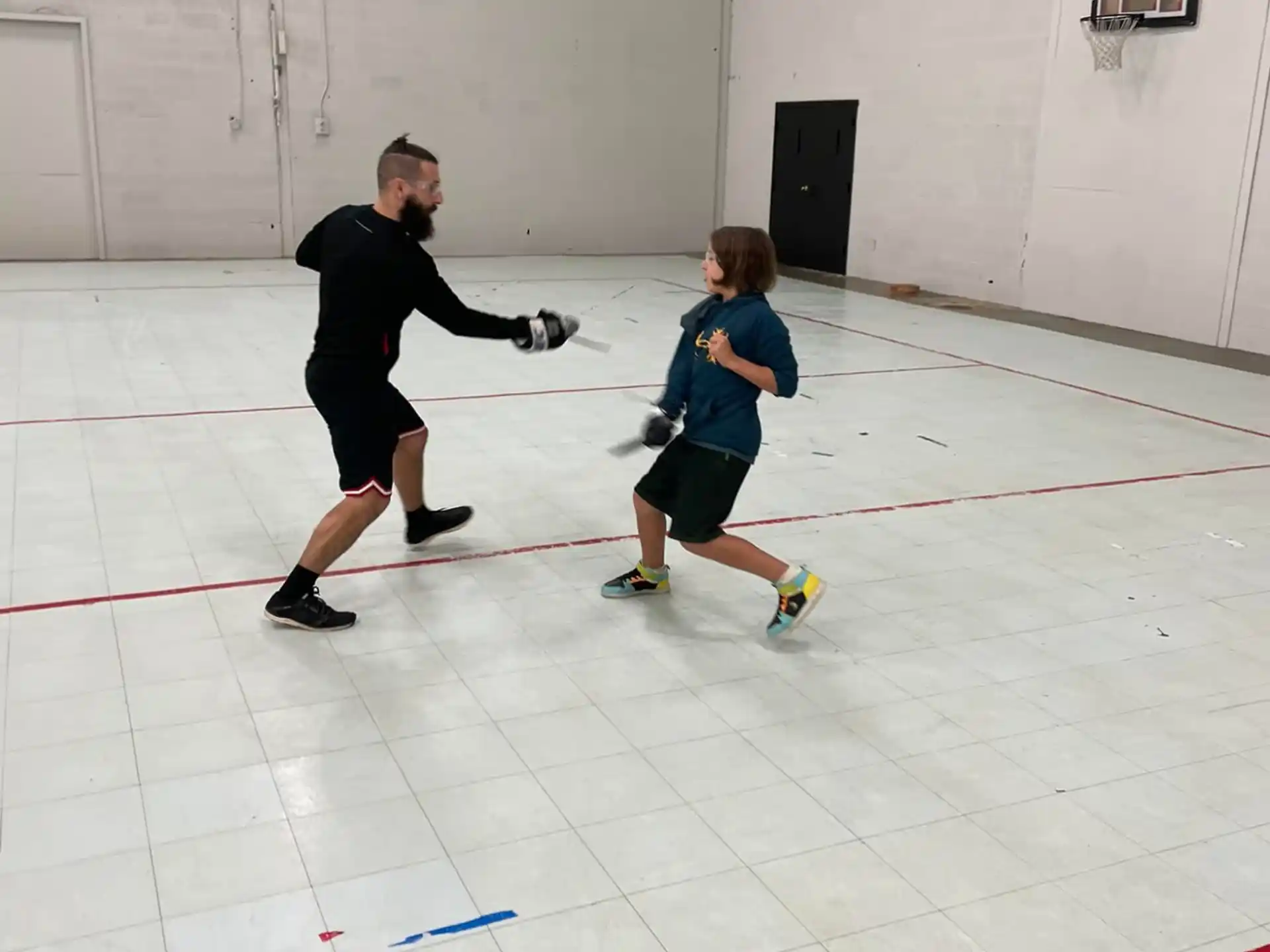 a man and a boy playing hockey