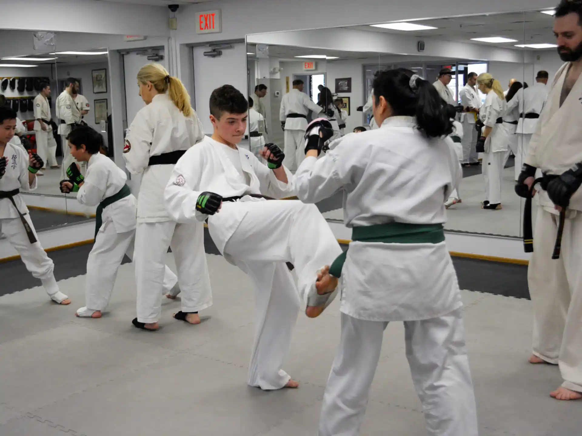 a group of people in white karate uniforms