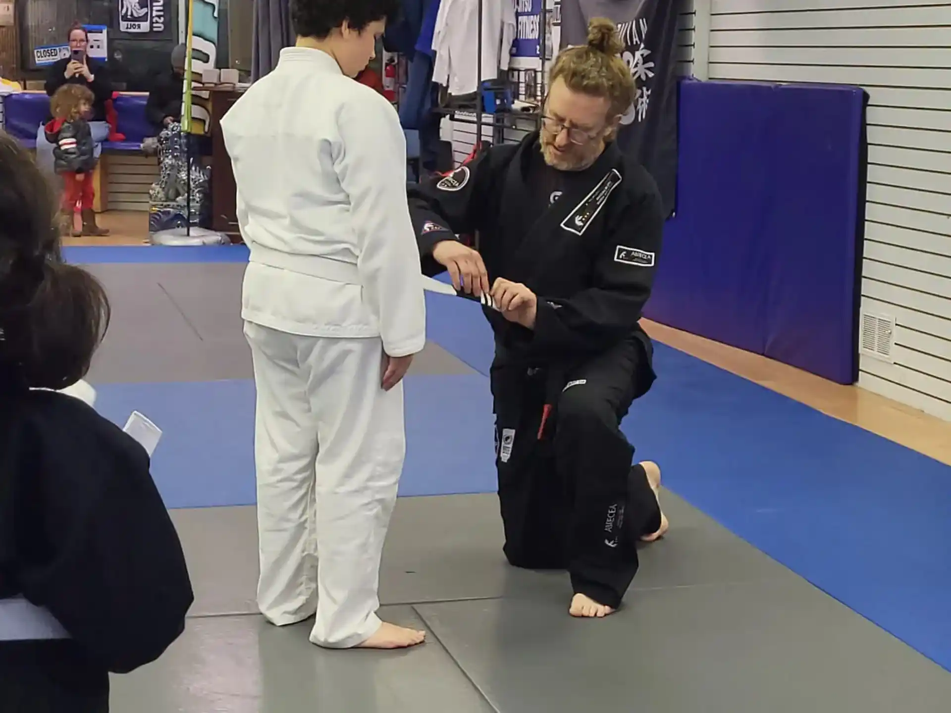 a woman handing a man a credit card