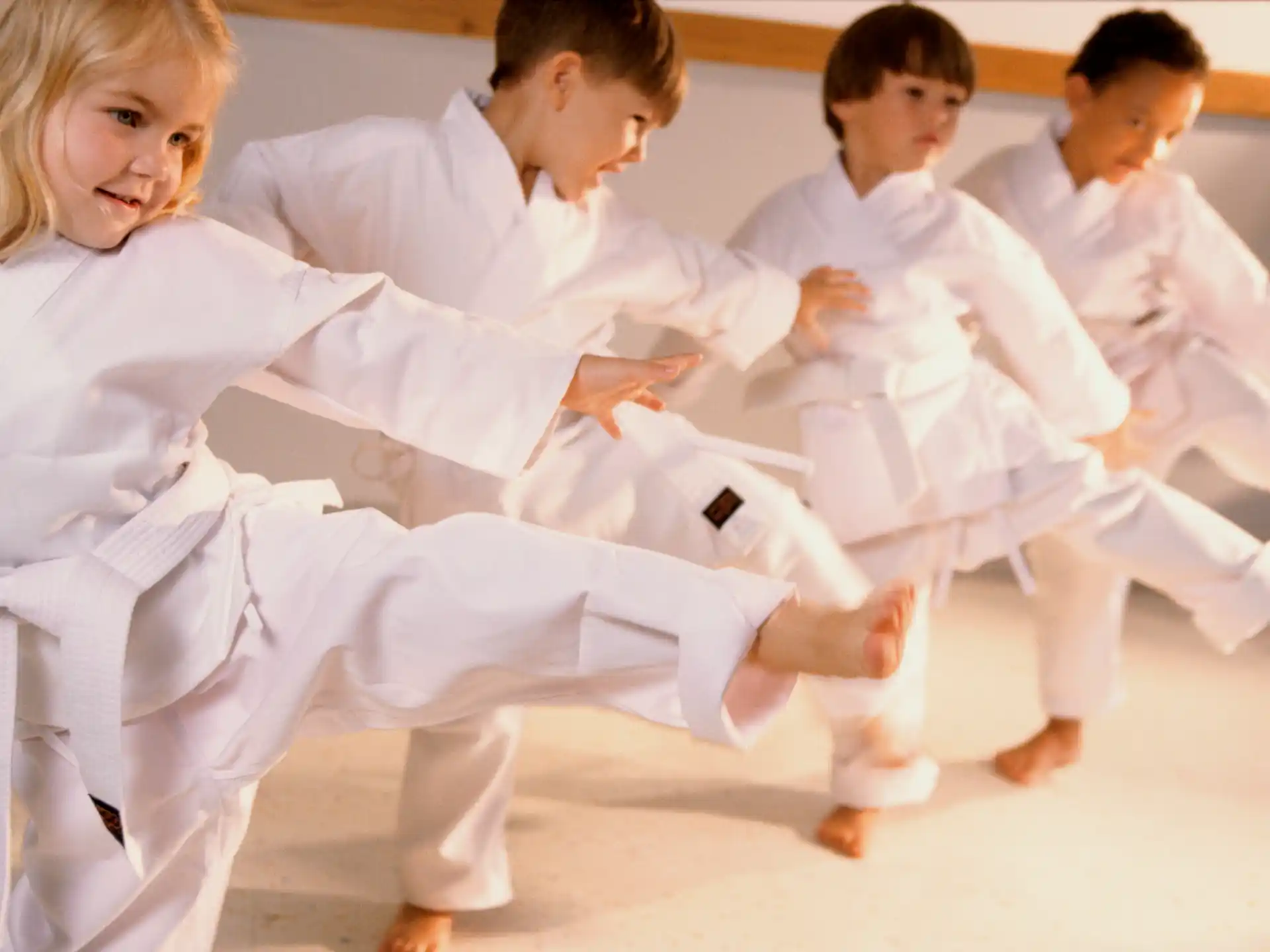a group of people in white karate uniforms