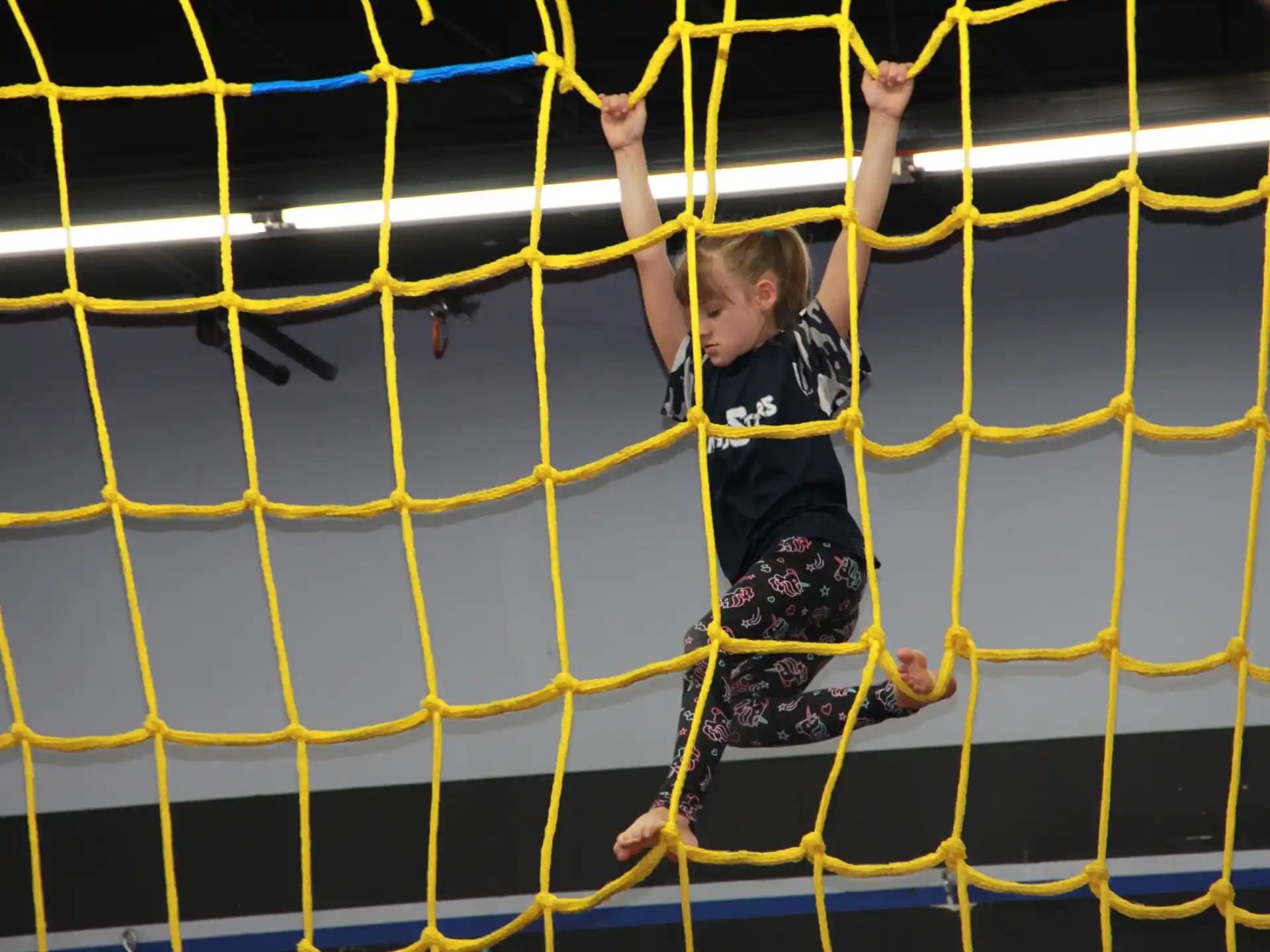 a girl climbing a net