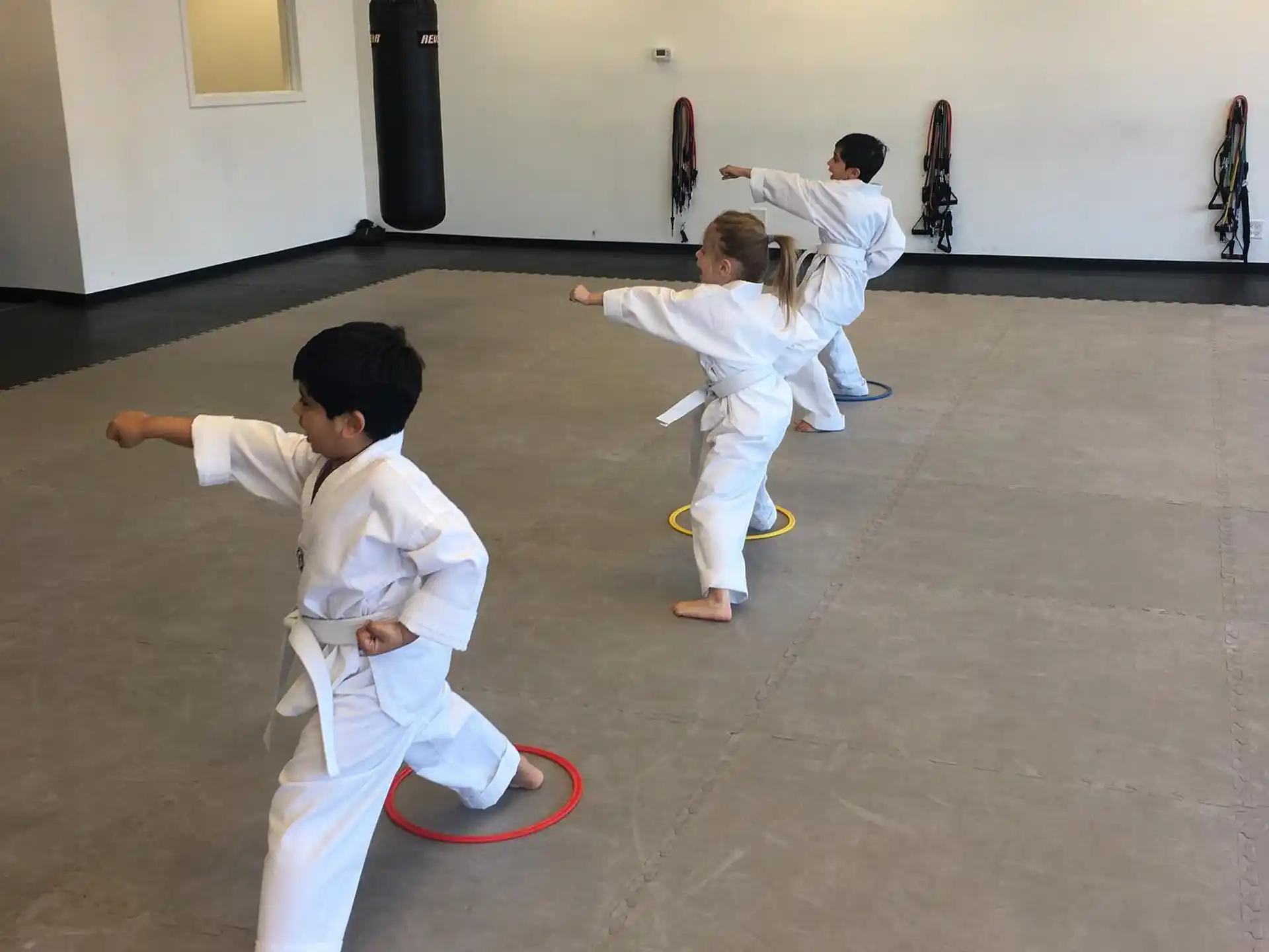 a group of kids practicing martial arts
