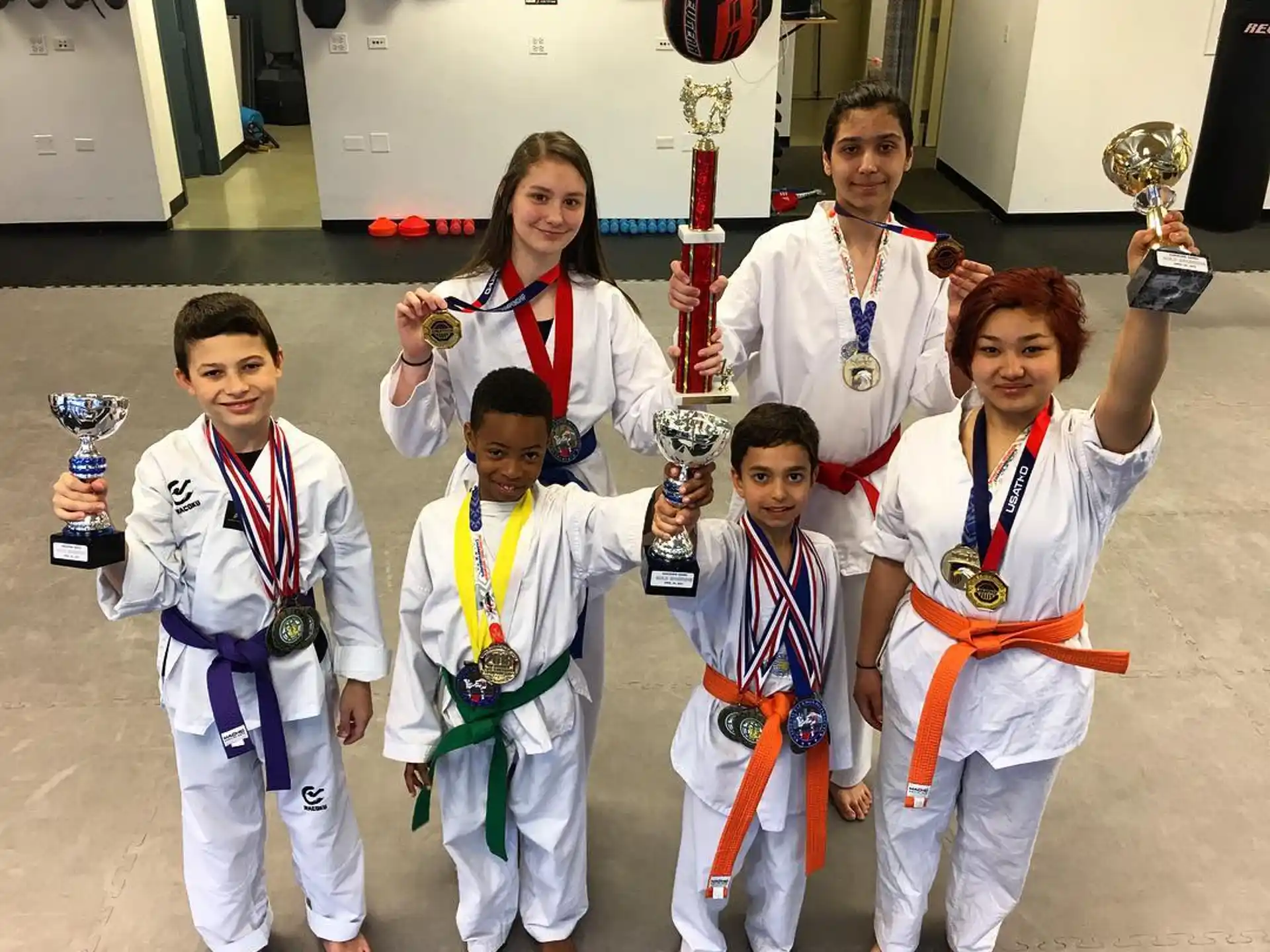 a group of people wearing medals and posing for a photo