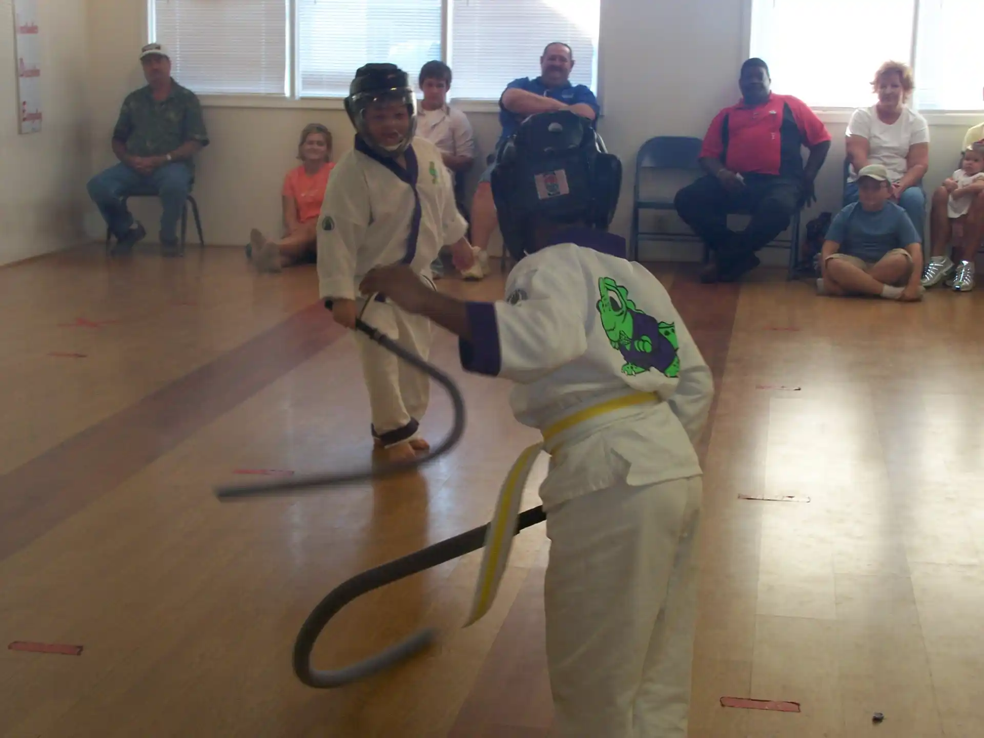 a person in a white uniform holding a sword in front of a group of people