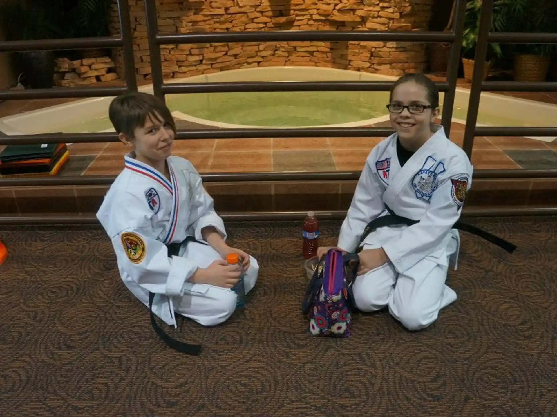 a person and a boy sitting on the ground
