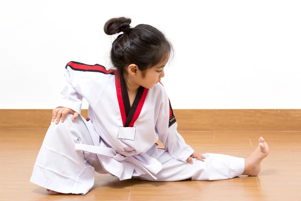 a young girl in a karate uniform