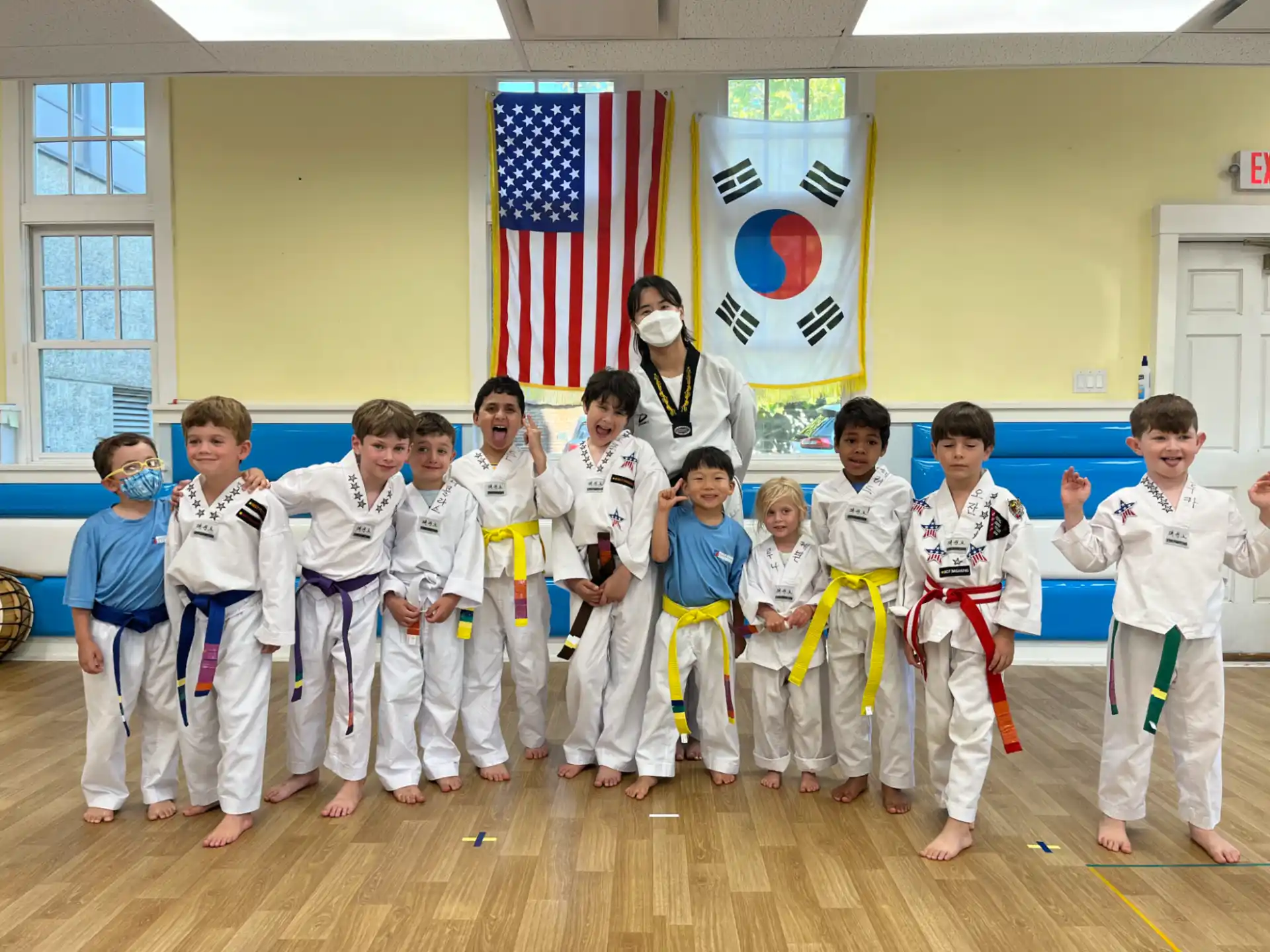 a group of kids in karate uniforms