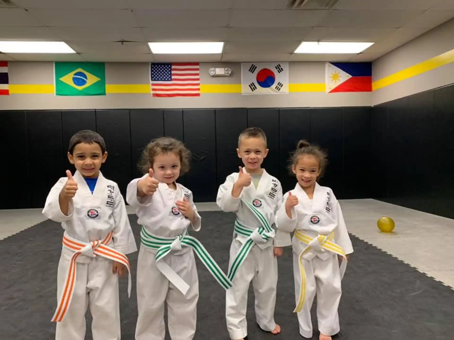 a group of children in karate uniforms