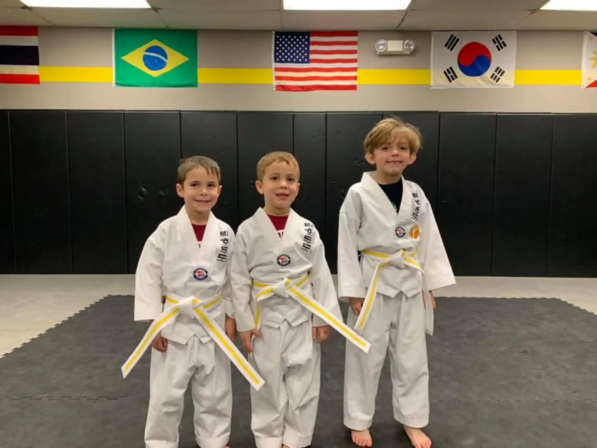 a group of kids in karate uniforms