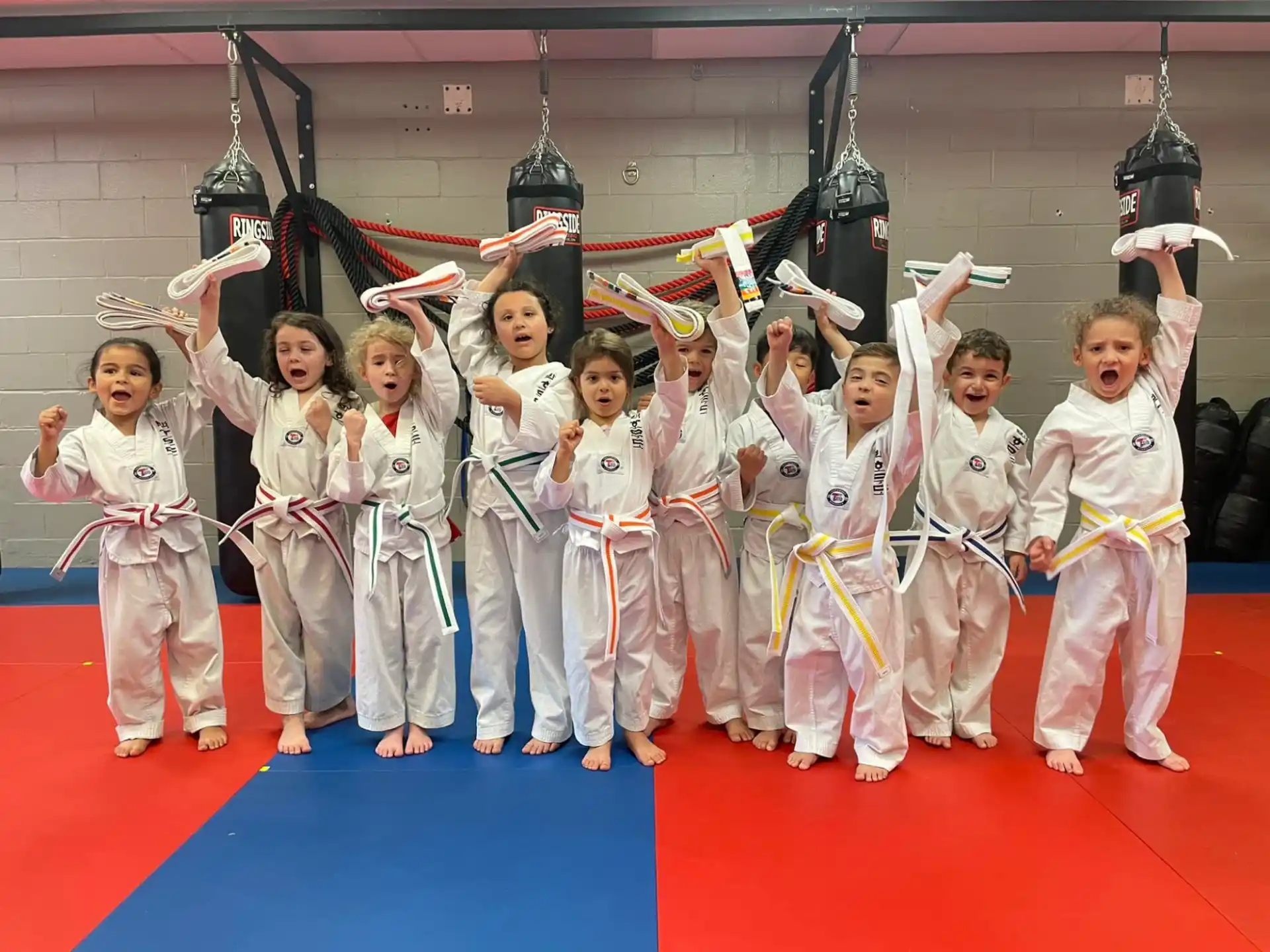 a group of people in white karate uniforms holding swords