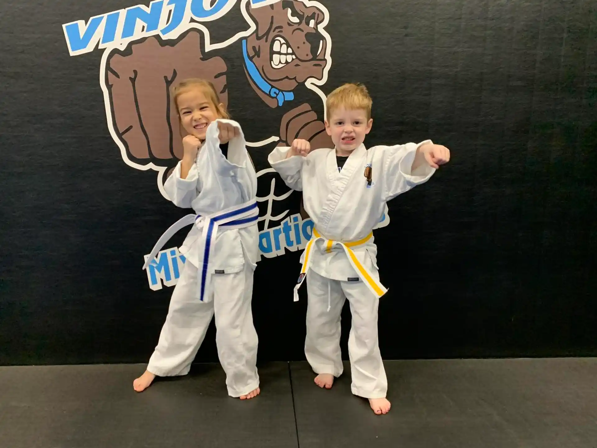 a boy and girl in karate uniforms