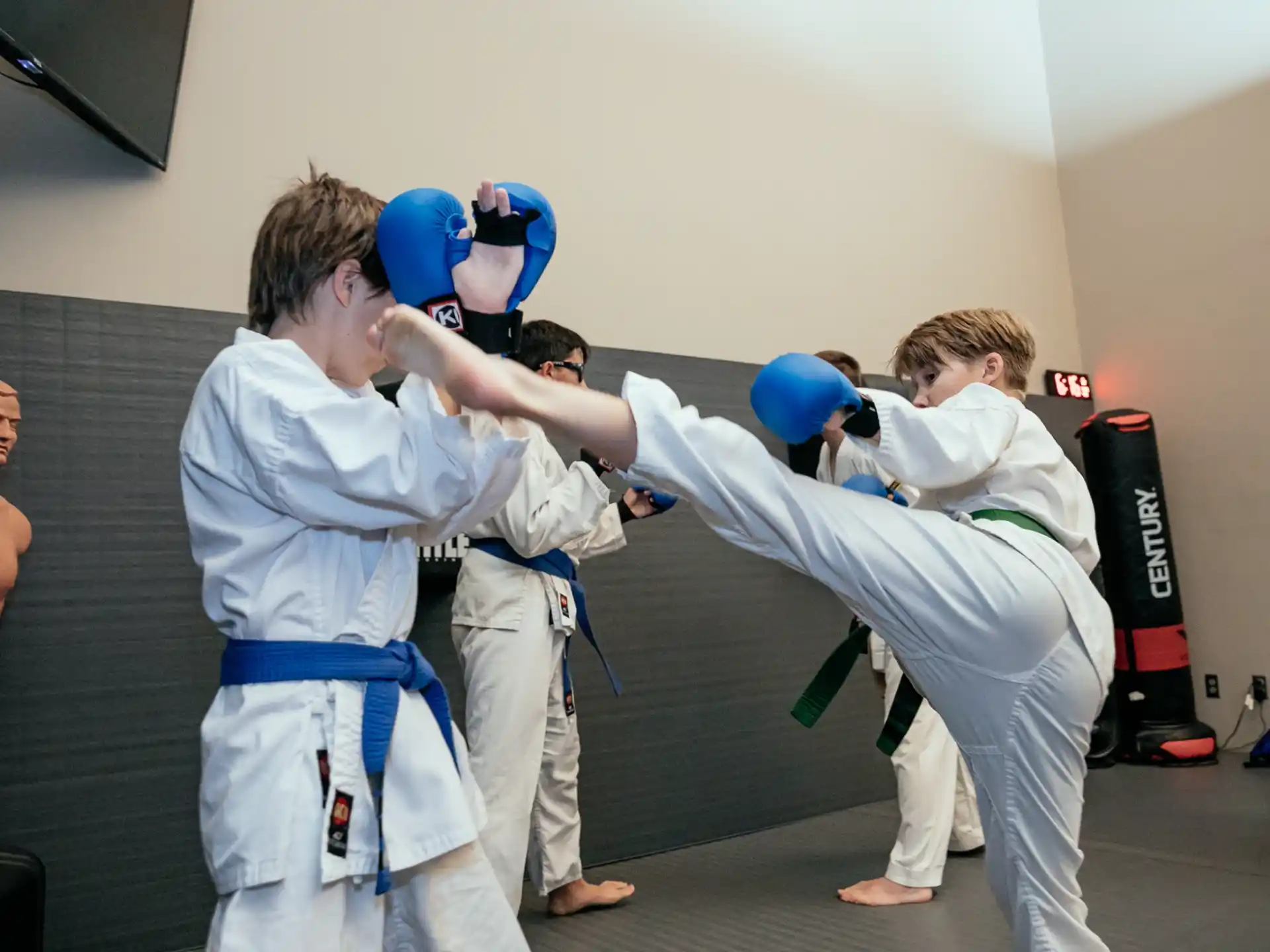 a group of people in white karate uniforms with blue balls