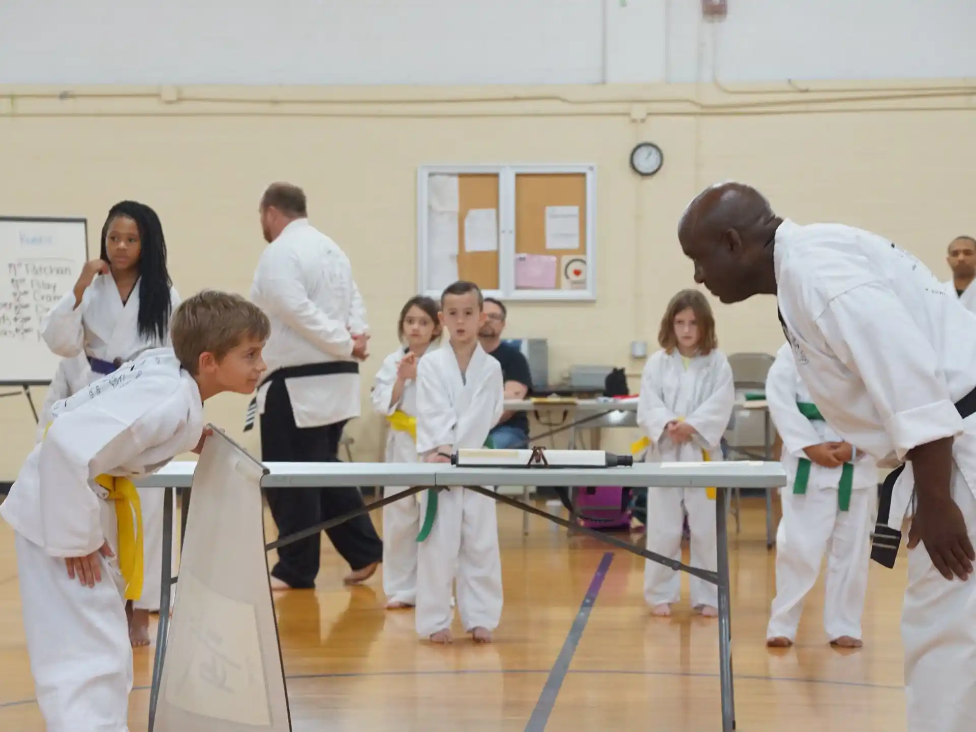 a group of people in white karate uniforms