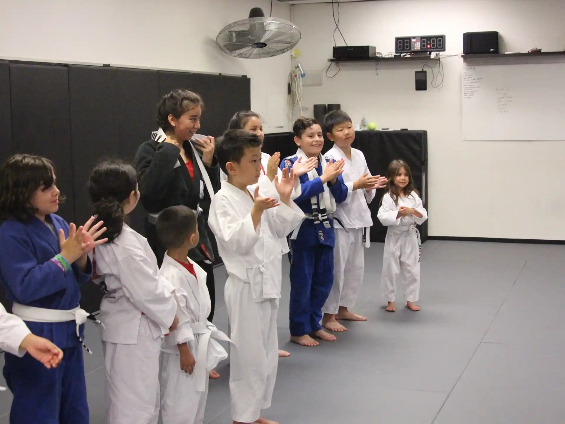 a group of people in white karate uniforms