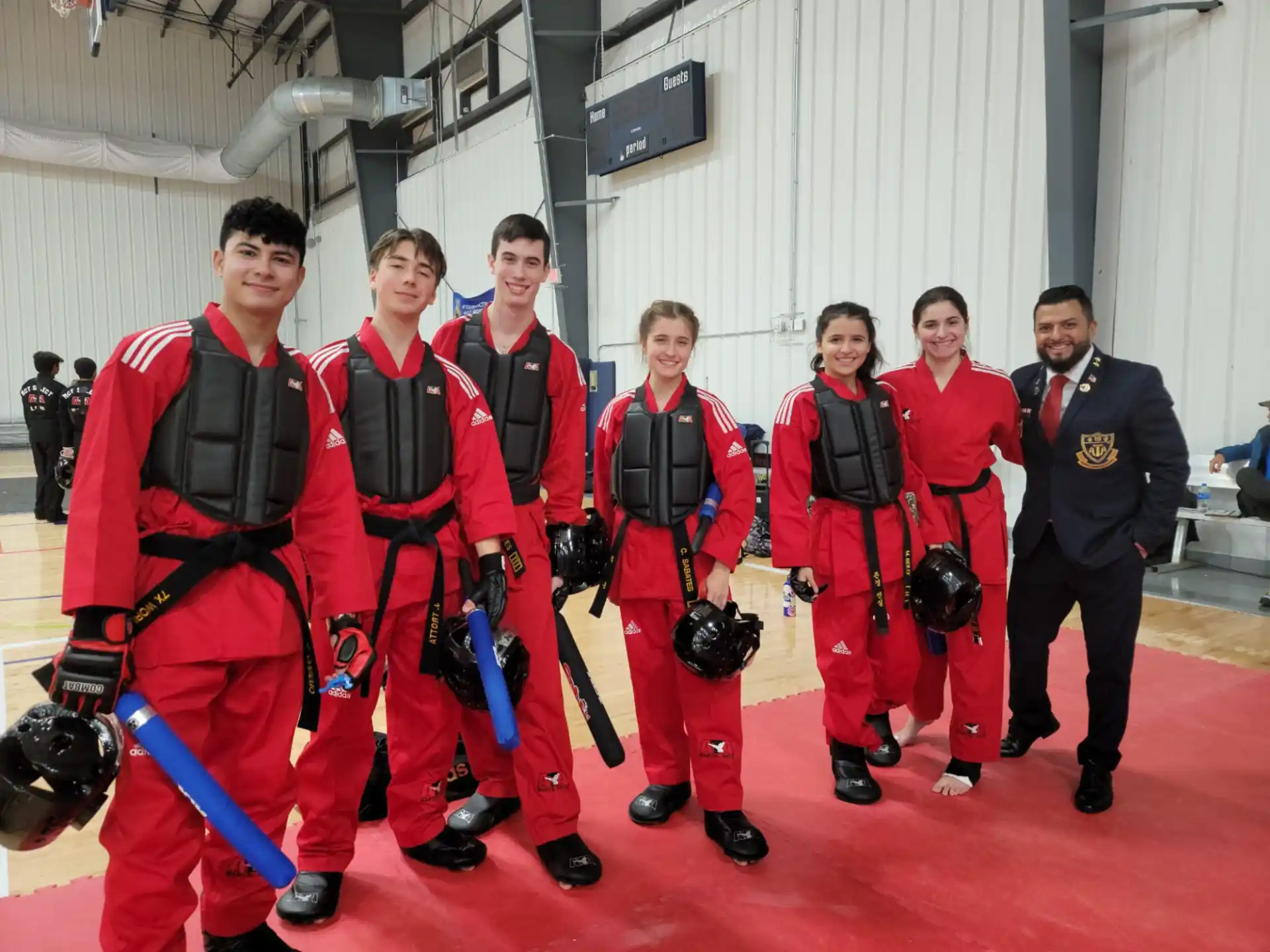 a group of people in red and black uniforms posing for a photo