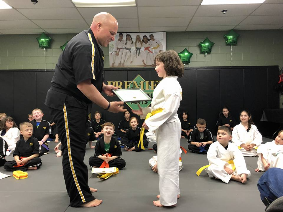 a man and a woman in karate uniforms with a man in the front