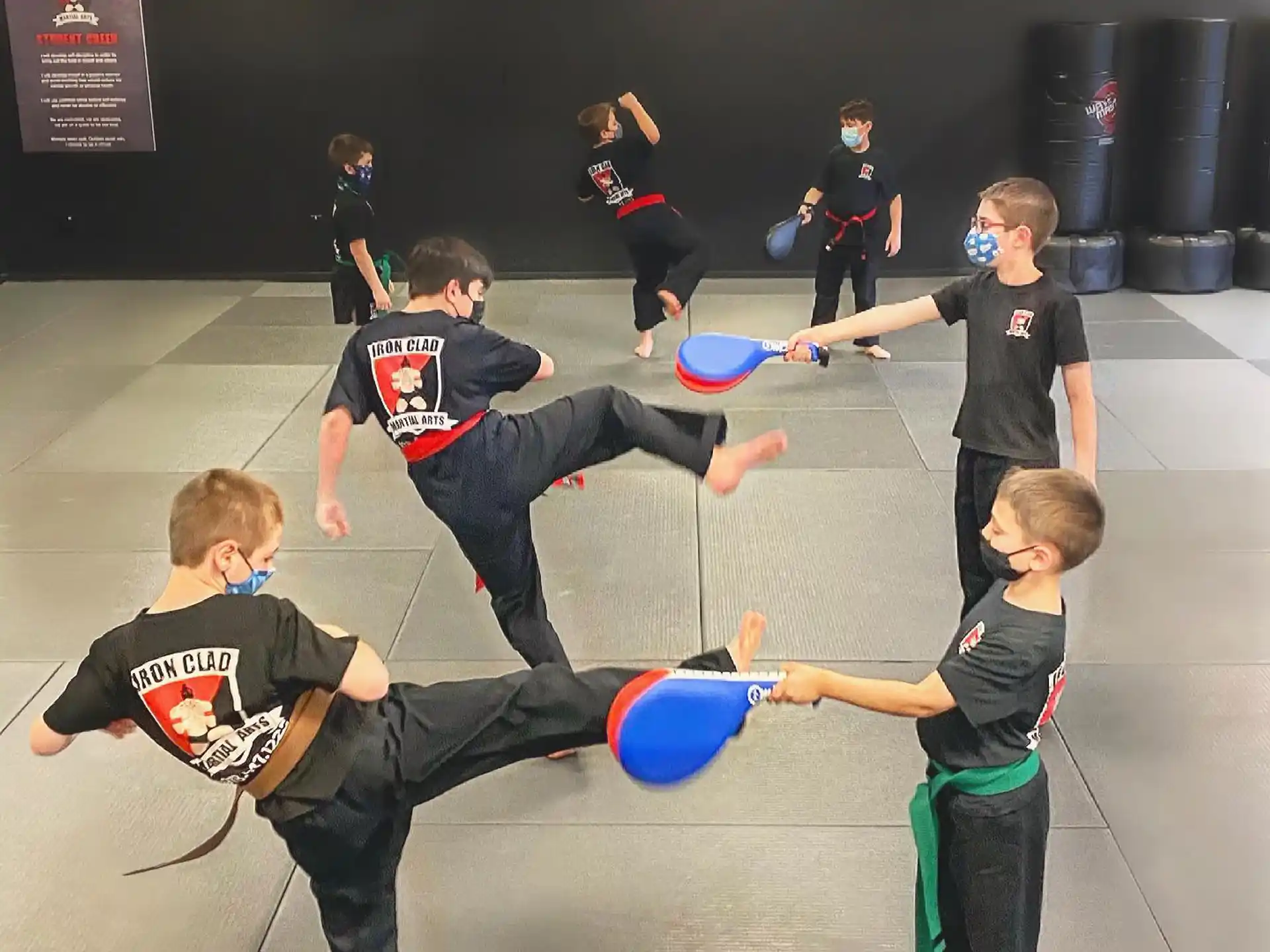 a group of kids playing with frisbees